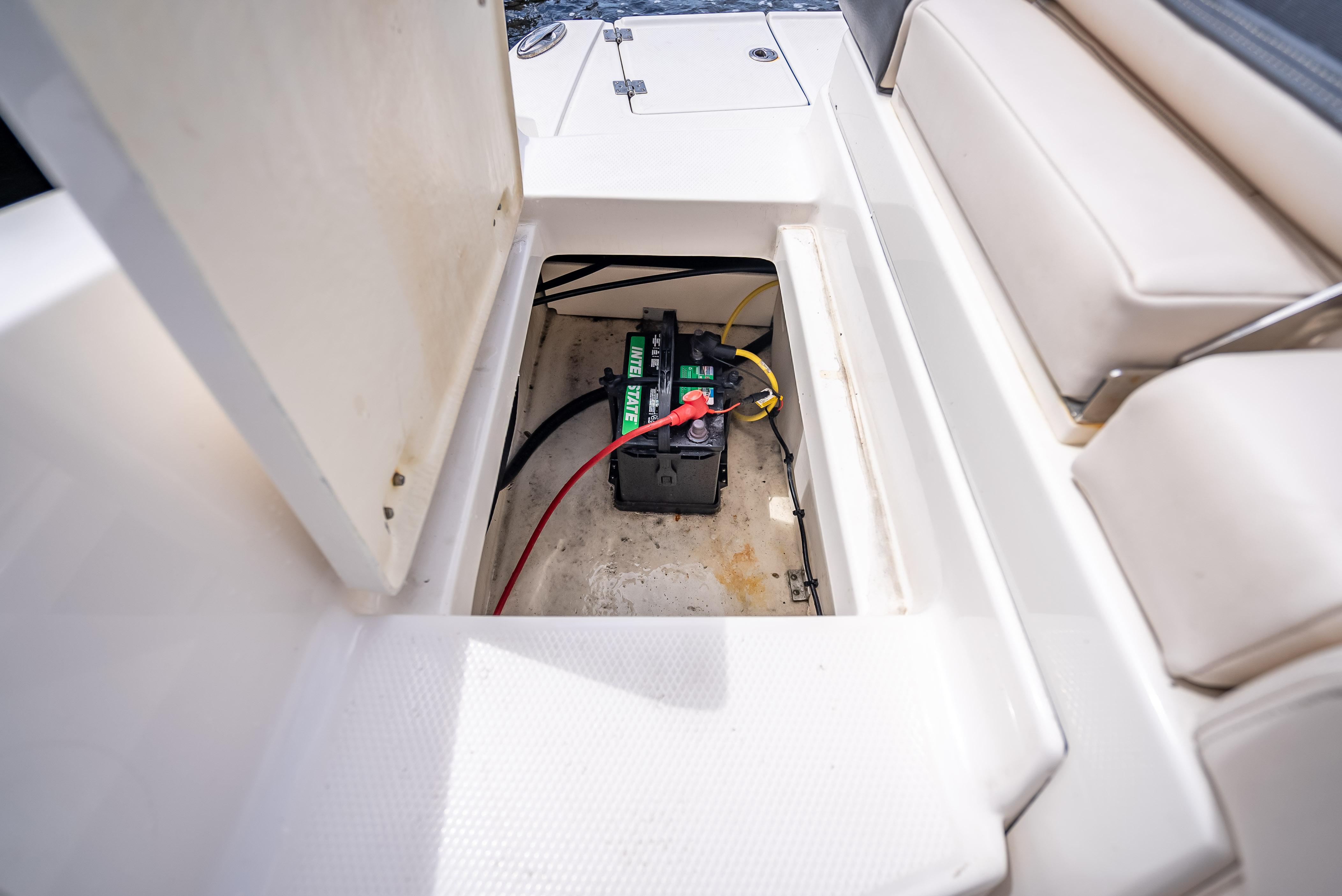 Battery compartment of 2017 Chaparral 227 SSX boat, featuring a marine battery.