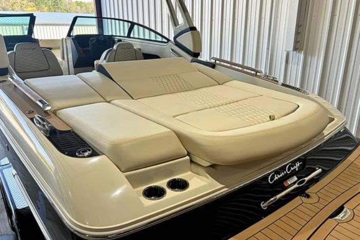 2025 Chris-Craft Sportster 25 boat with luxurious seating and sleek design in a storage facility.