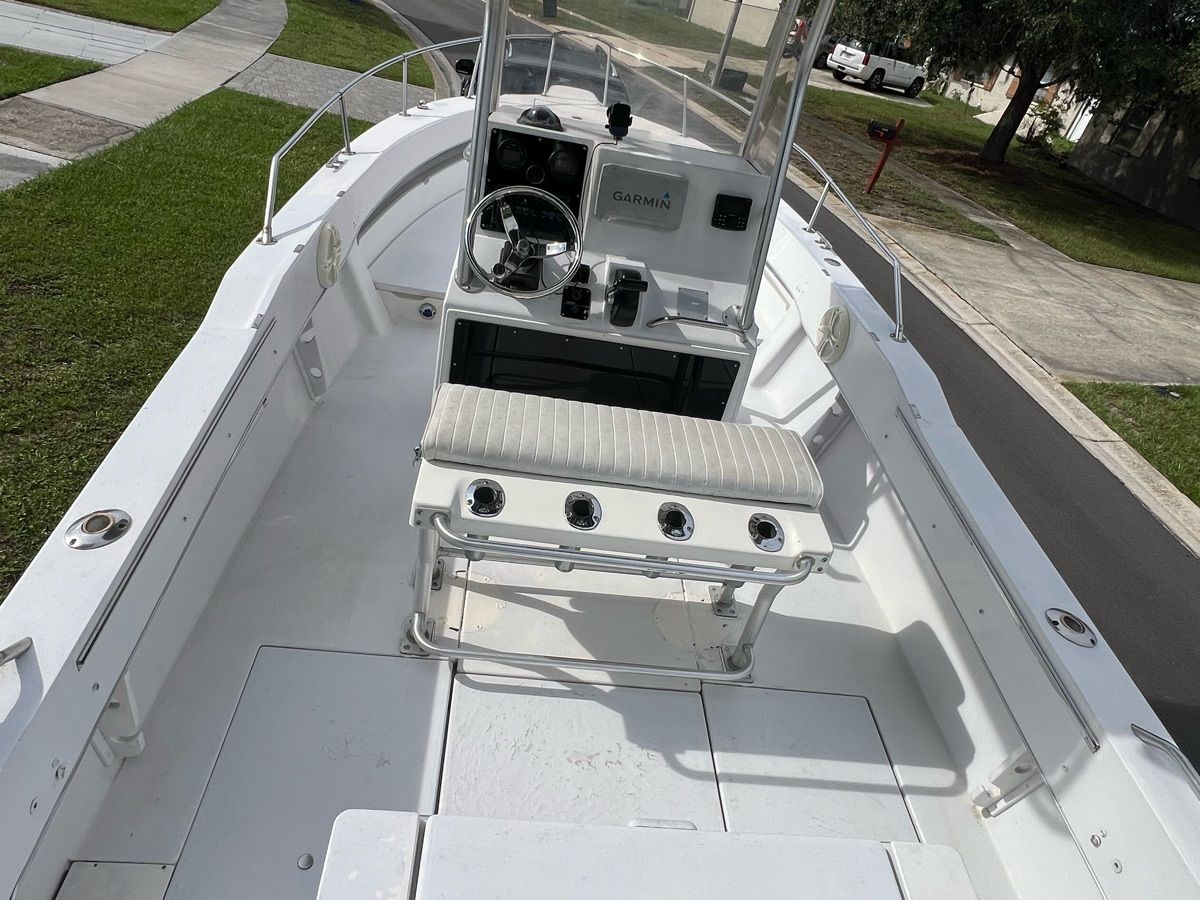 A 1994 Sea Ray Laguna boat with open deck and helm console, parked on a lawn.