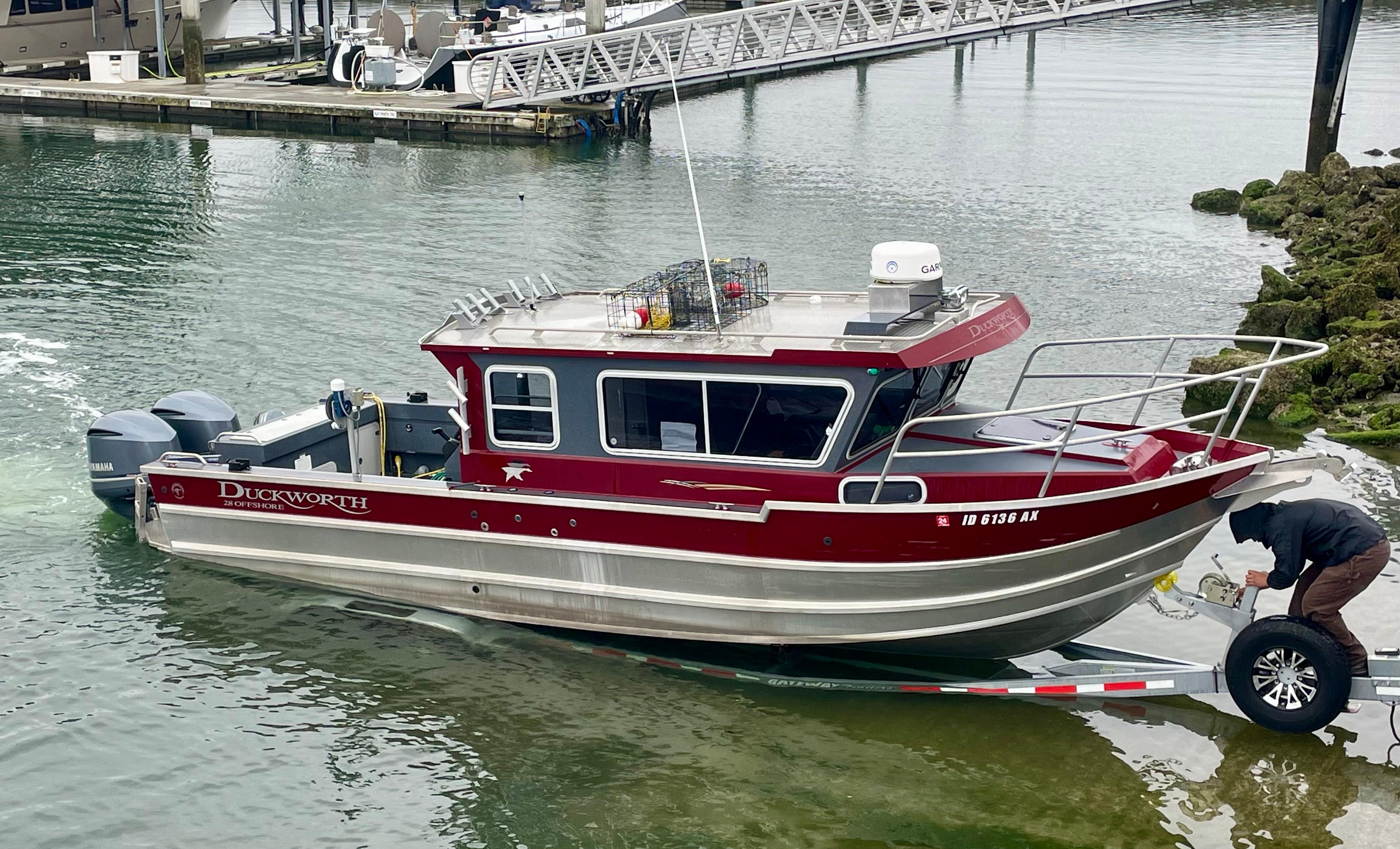 2018 Duckworth 28 Offshore boat being launched at a marina.