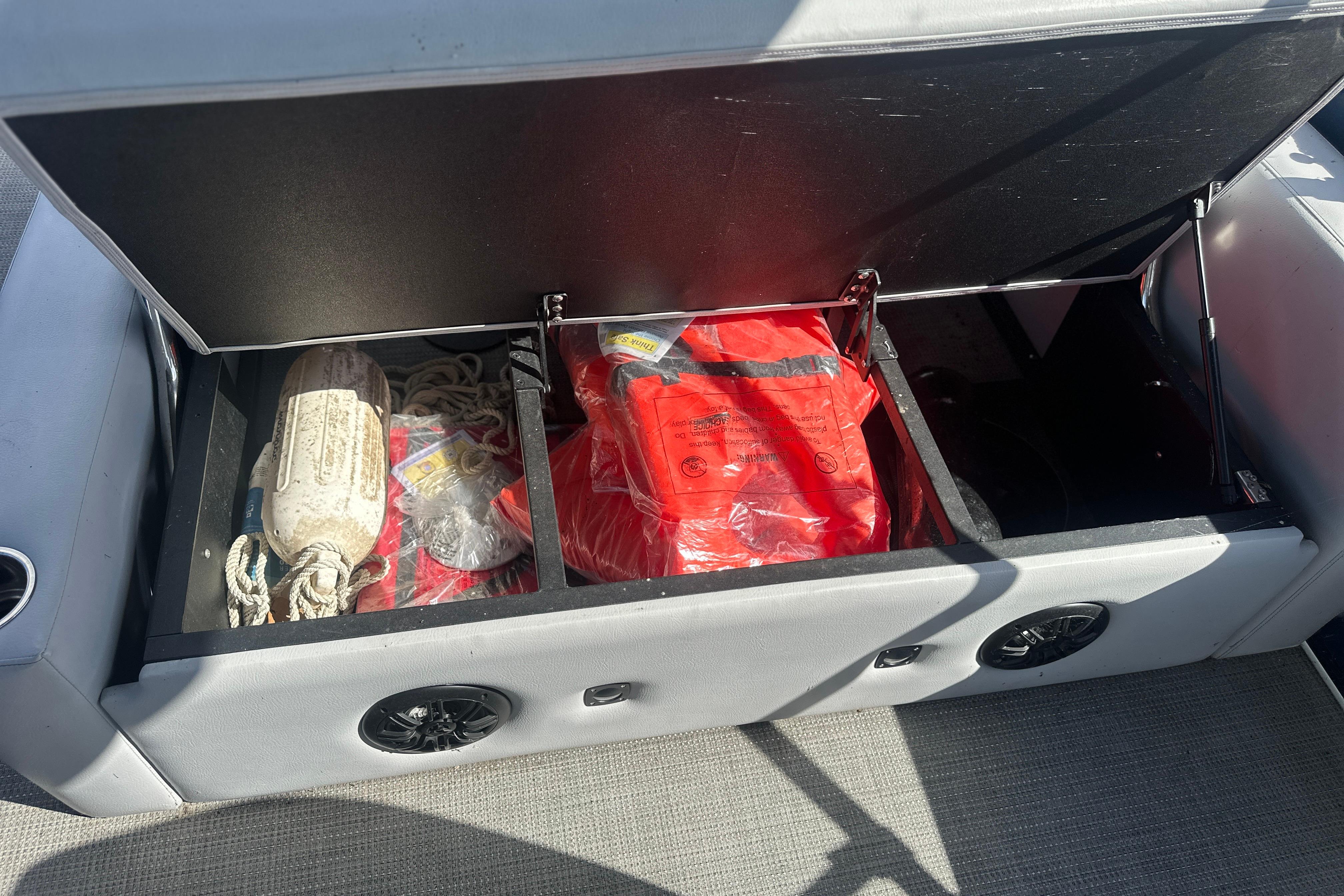 Storage compartment in 2023 Bentley Pontoons Legacy 243 Swingback, containing ropes and safety equipment.