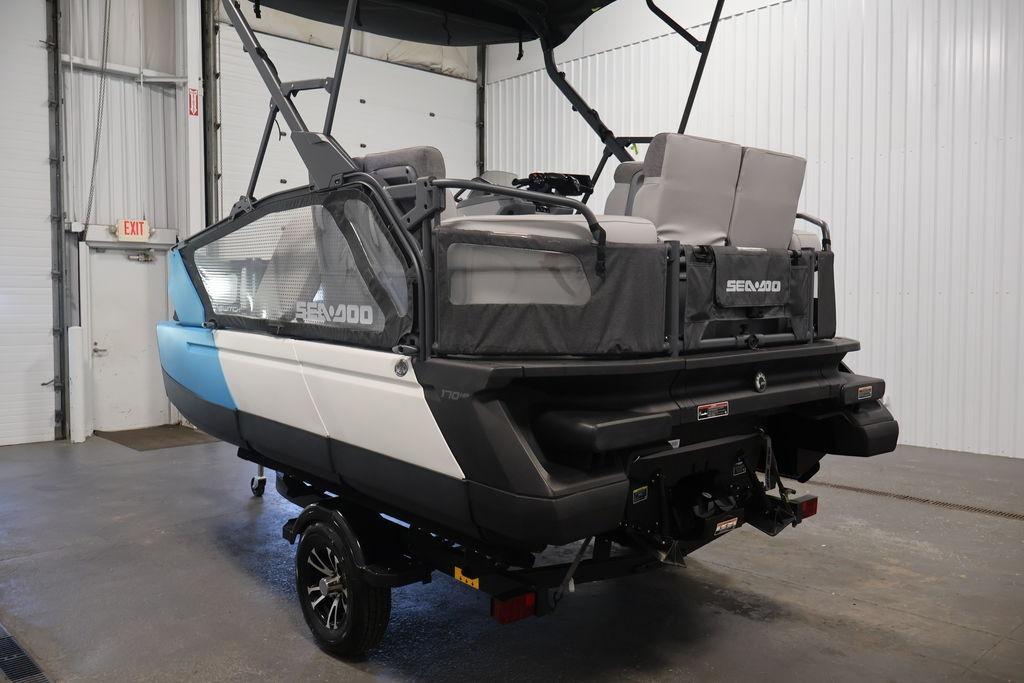 2023 Sea-Doo Switch Sport Compact in a garage, showcasing rear design and seating.