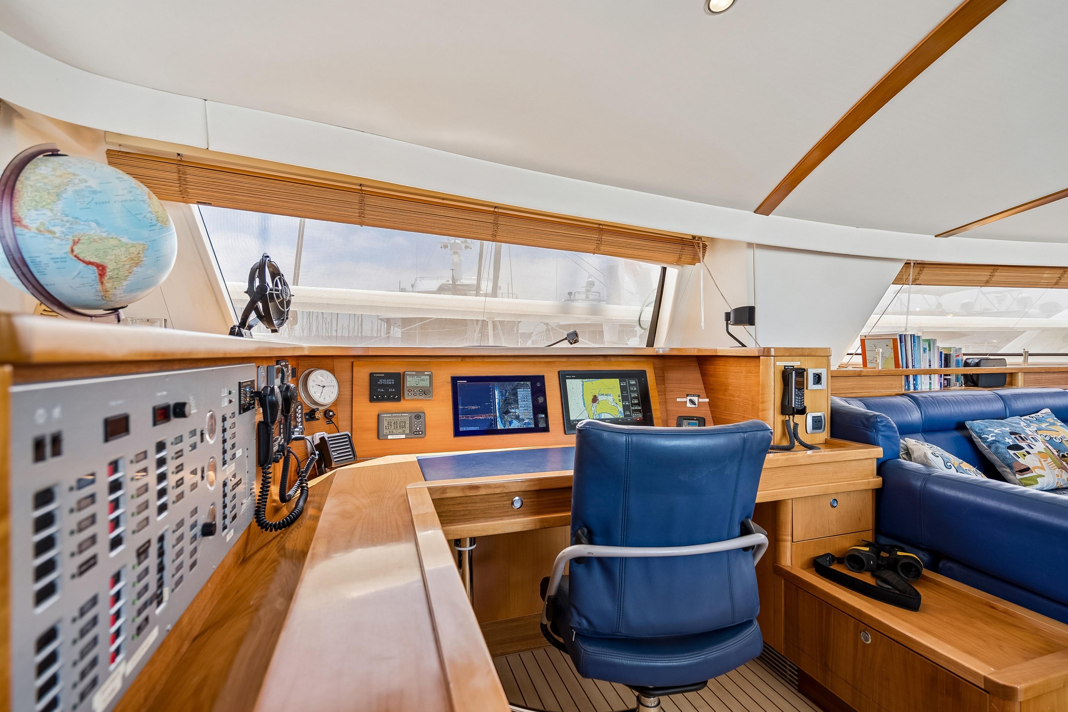 Luxurious 2009 Catana 65 yacht interior with navigation station and plush seating.