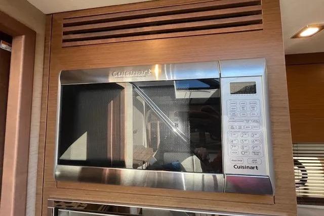 Cuisinart microwave in 2016 Sea Ray Sundancer 510 yacht kitchen, featuring modern wood paneling.