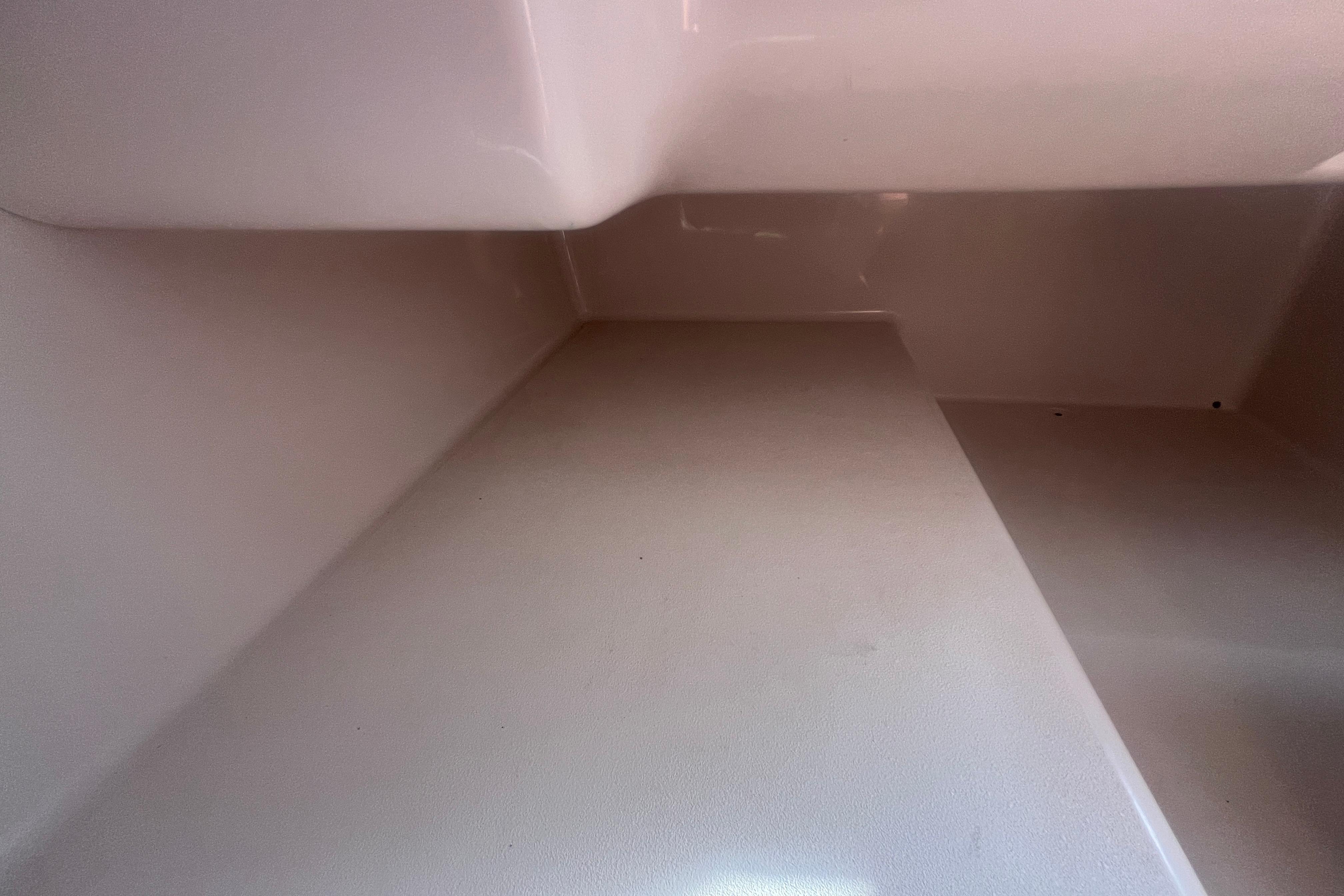Interior compartment of a 2002 Hurricane SunDeck 260 OB boat, showcasing clean, smooth surfaces.