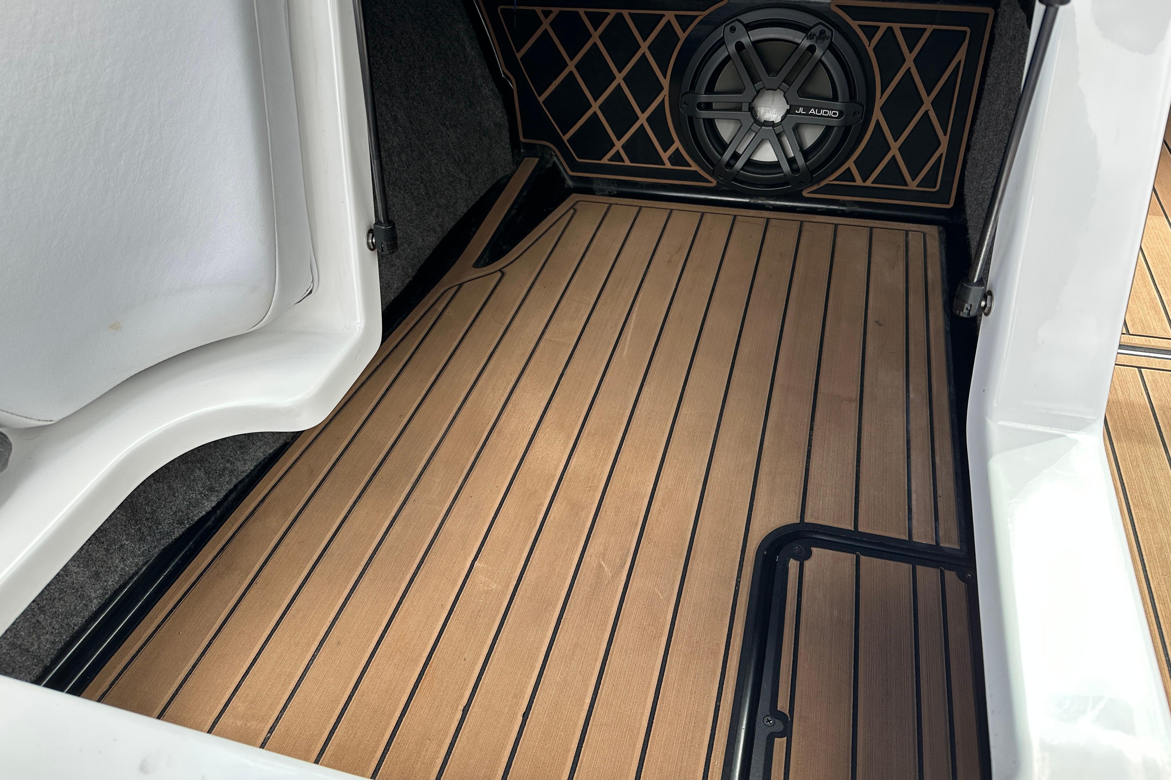 2017 Nautique Super Air Nautique GS20 interior with teak flooring and JL Audio speaker.