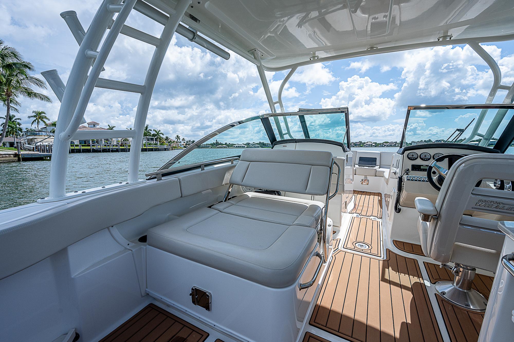 2018 Boston Whaler 270 Vantage boat interior with seating and helm, on a sunny day.