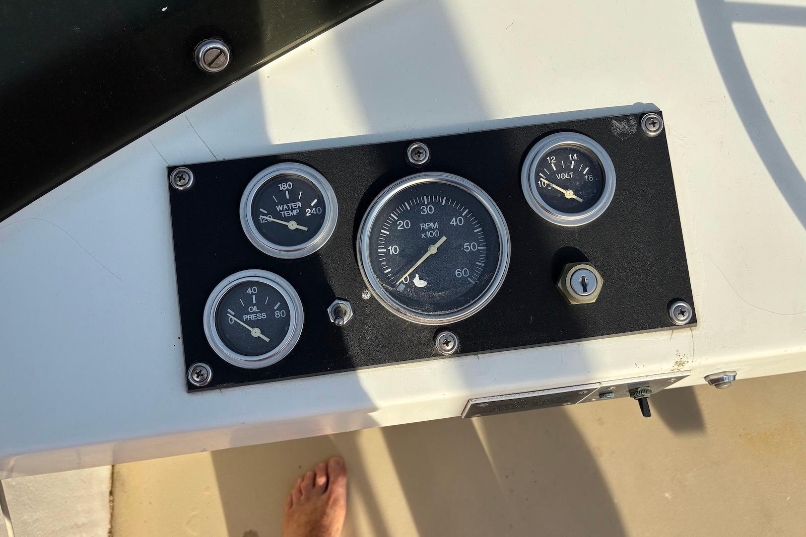 Dashboard gauges of a 1987 Cape Dory 28 Flybridge boat, showing RPM, water temperature, oil pressure, and voltage.