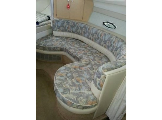 2000 Bayliner 3055 Ciera Sunbridge interior seating area with patterned upholstery.