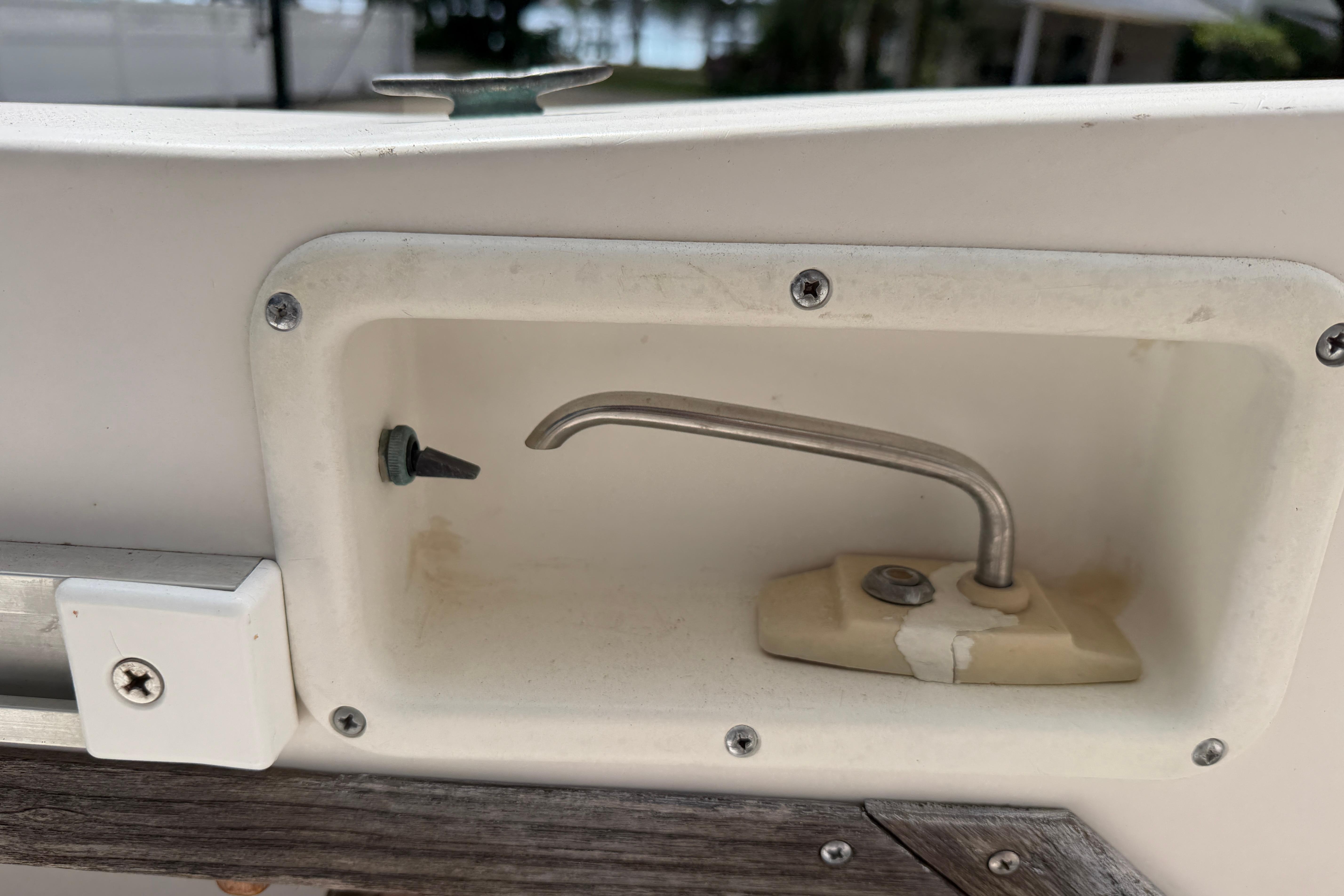 1987 Grady-White Seafarer 226 boat detail showing a metal hook and mounting screws.