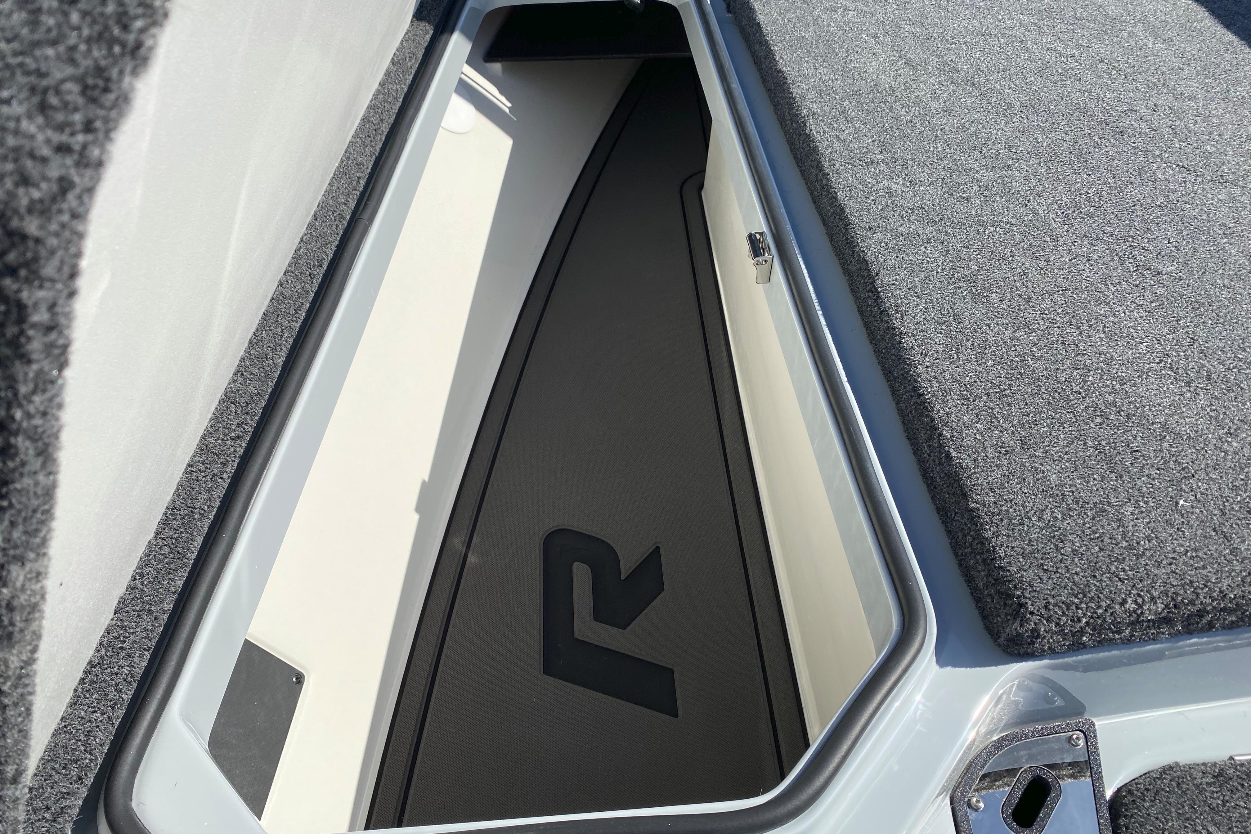 2026 Ranger Z519R boat storage compartment with carpeted interior and logo.