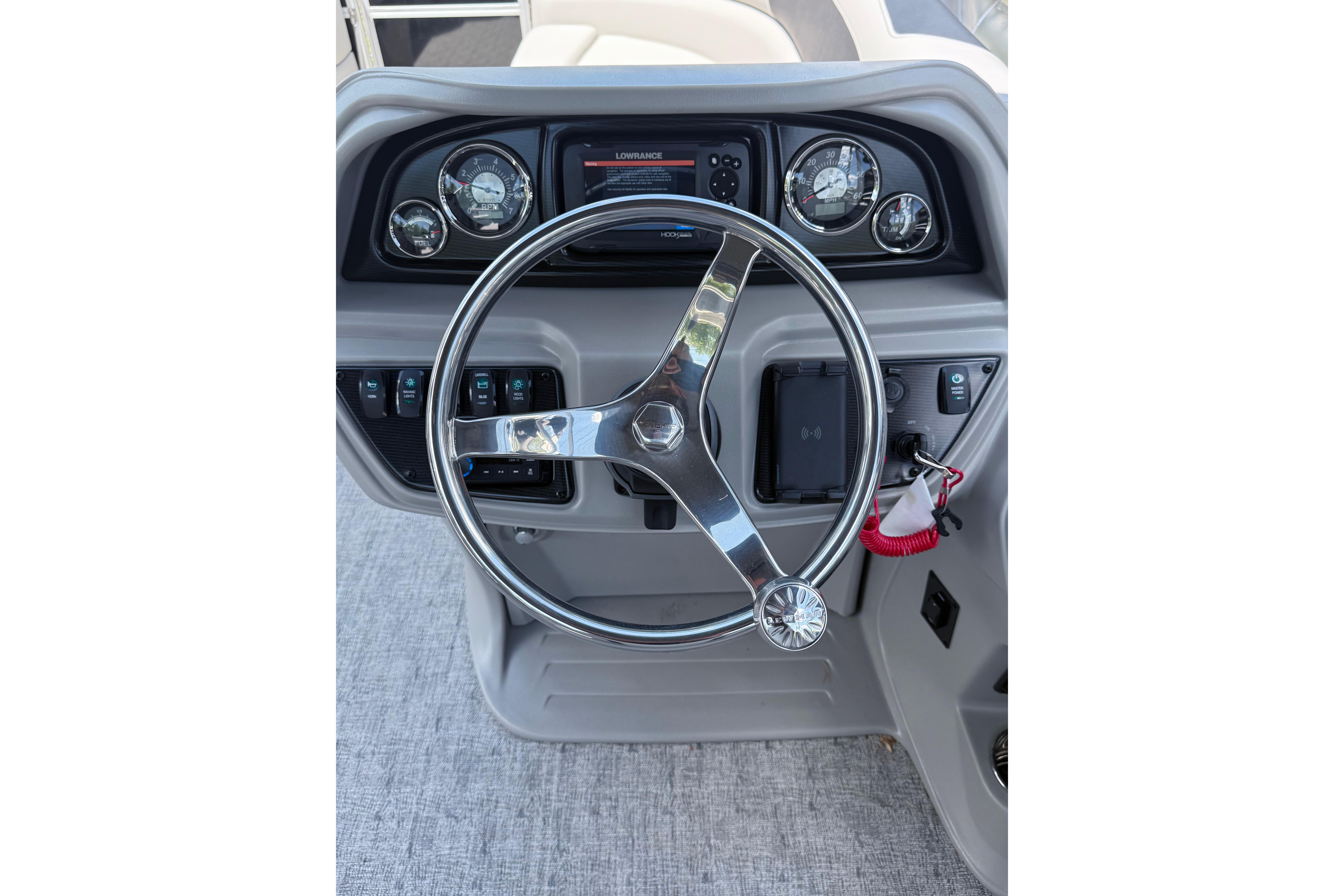 Steering console of 2026 Berkshire 24RFX LE boat with gauges and controls.