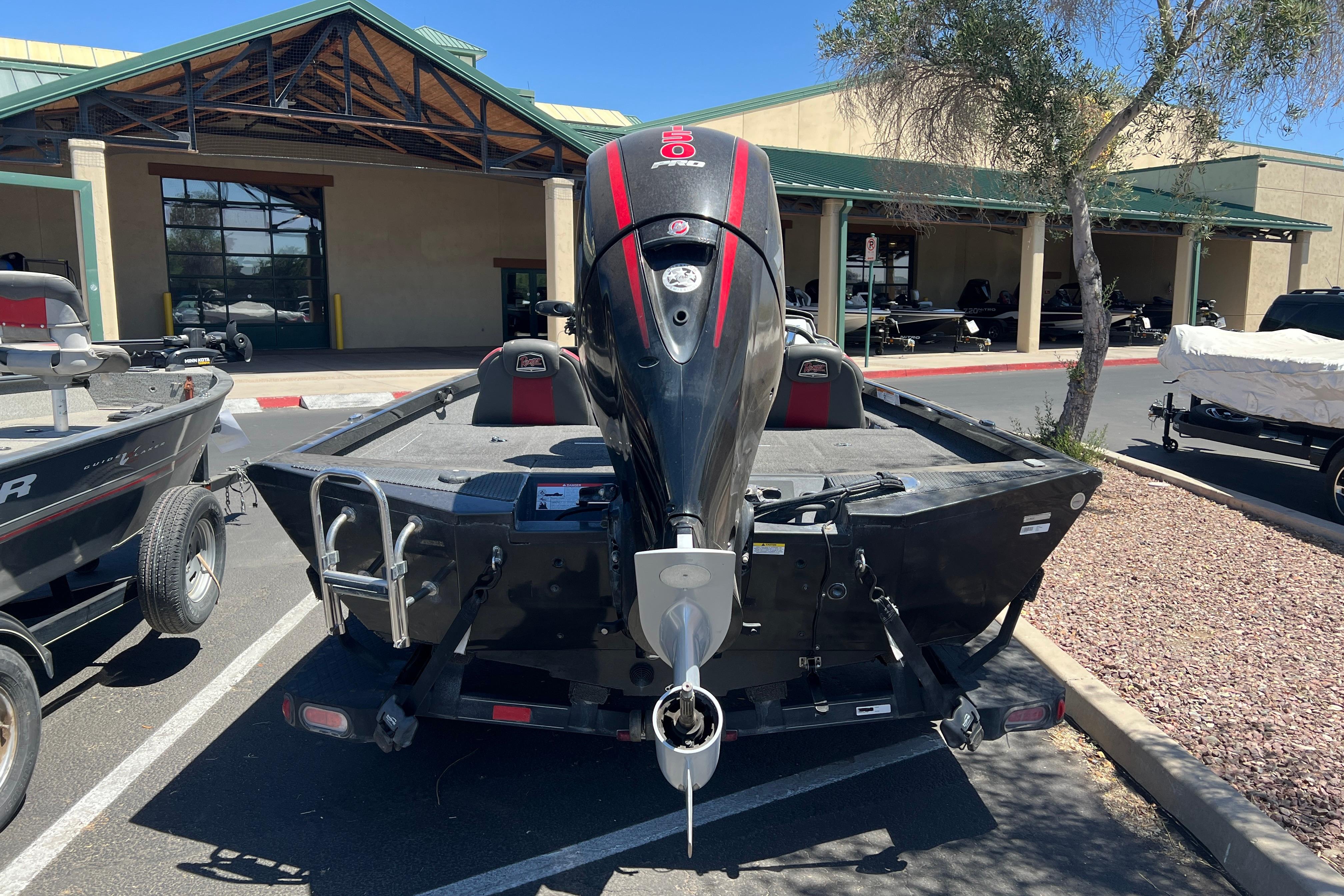 2019 Ranger RT198P boat with outboard motor in a parking lot.