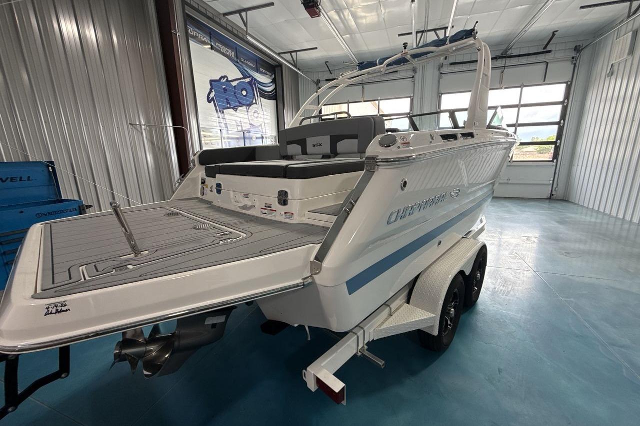 The image shows a modern Chaparral SSX 4 boat from 2026 in a storage facility.