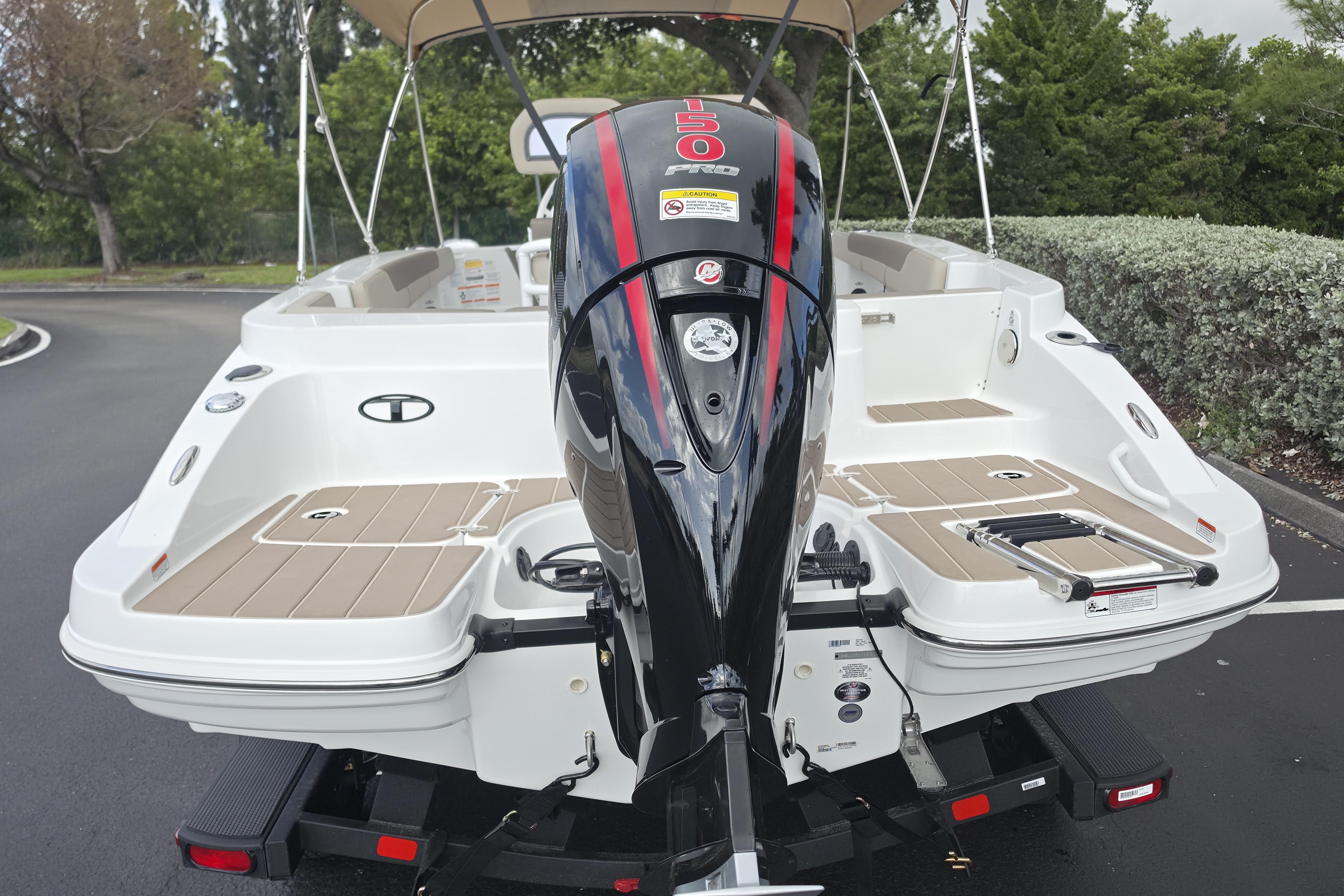 2026 Tahoe 2150 CC boat with powerful outboard motor, parked outdoors.