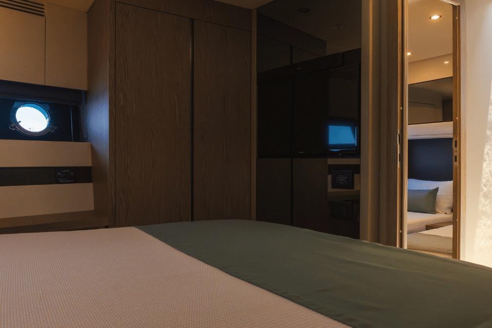 Luxurious interior of 2020 Azimut 60 yacht cabin with modern design and cozy bedding.