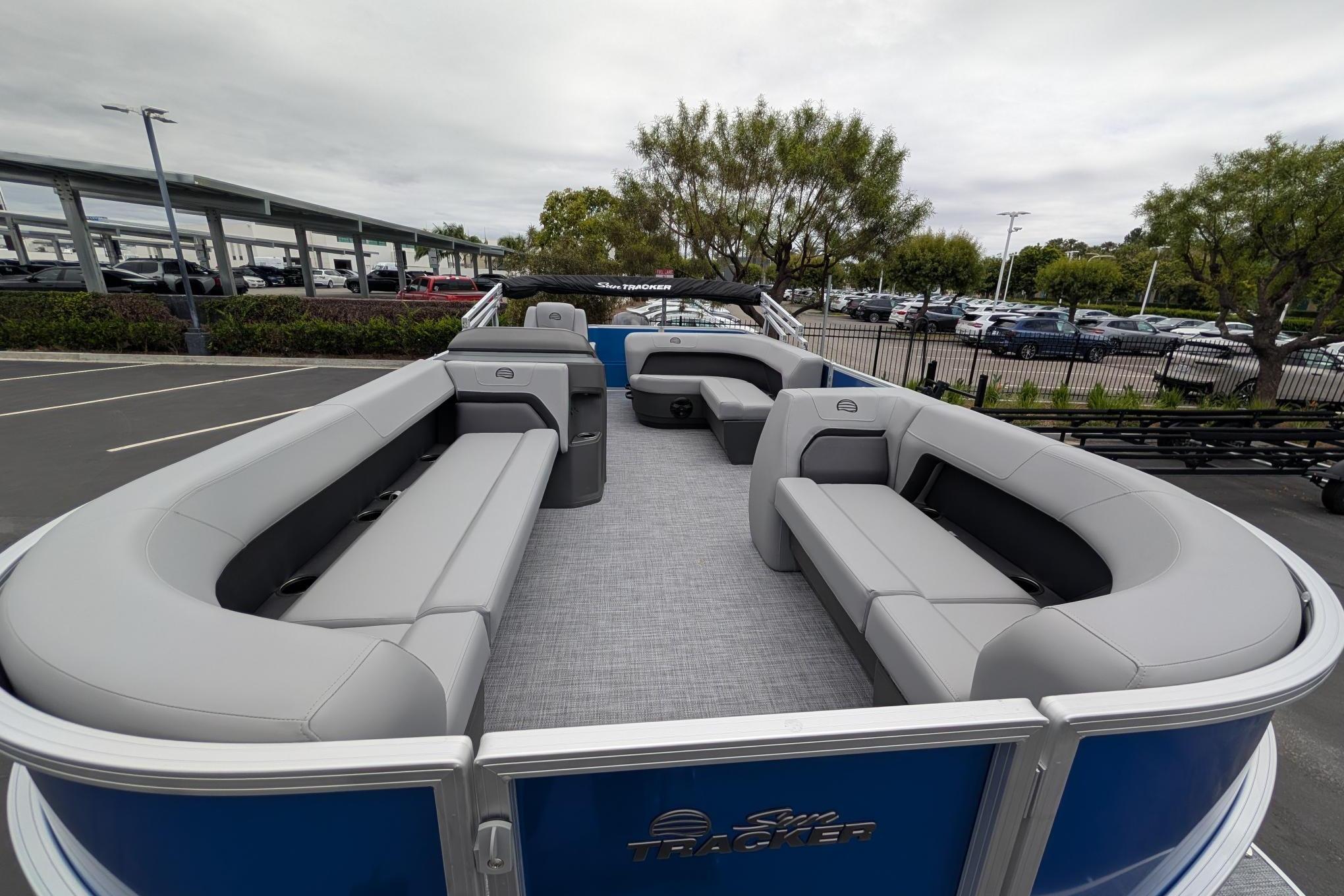 2026 Sun Tracker Party Barge 18 DLX with spacious seating, parked outdoors.