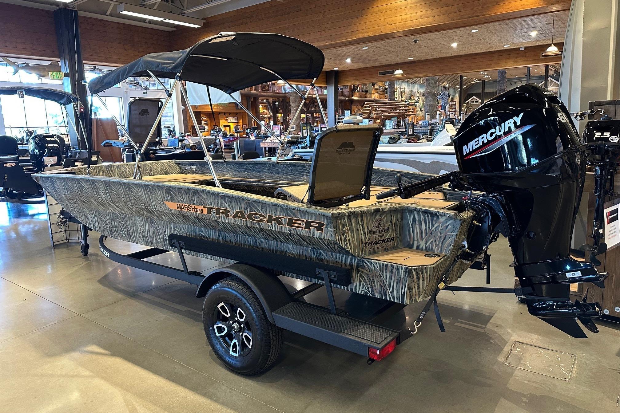2026 Tracker Grizzly 1756 T Marsh boat with Mercury engine on display in showroom.
