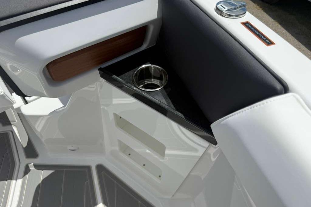 Interior detail of 2026 Monterey Elite 30 OB boat with cup holder and sleek design.