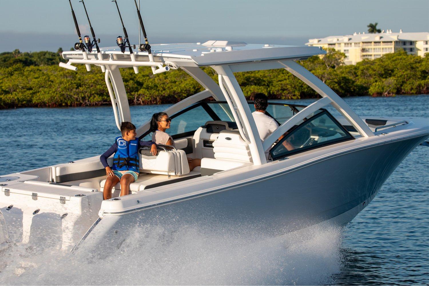 Manufacturer Provided Image: 2026 Robalo R277 Dual Console boat cruising with passengers on a sunny day.