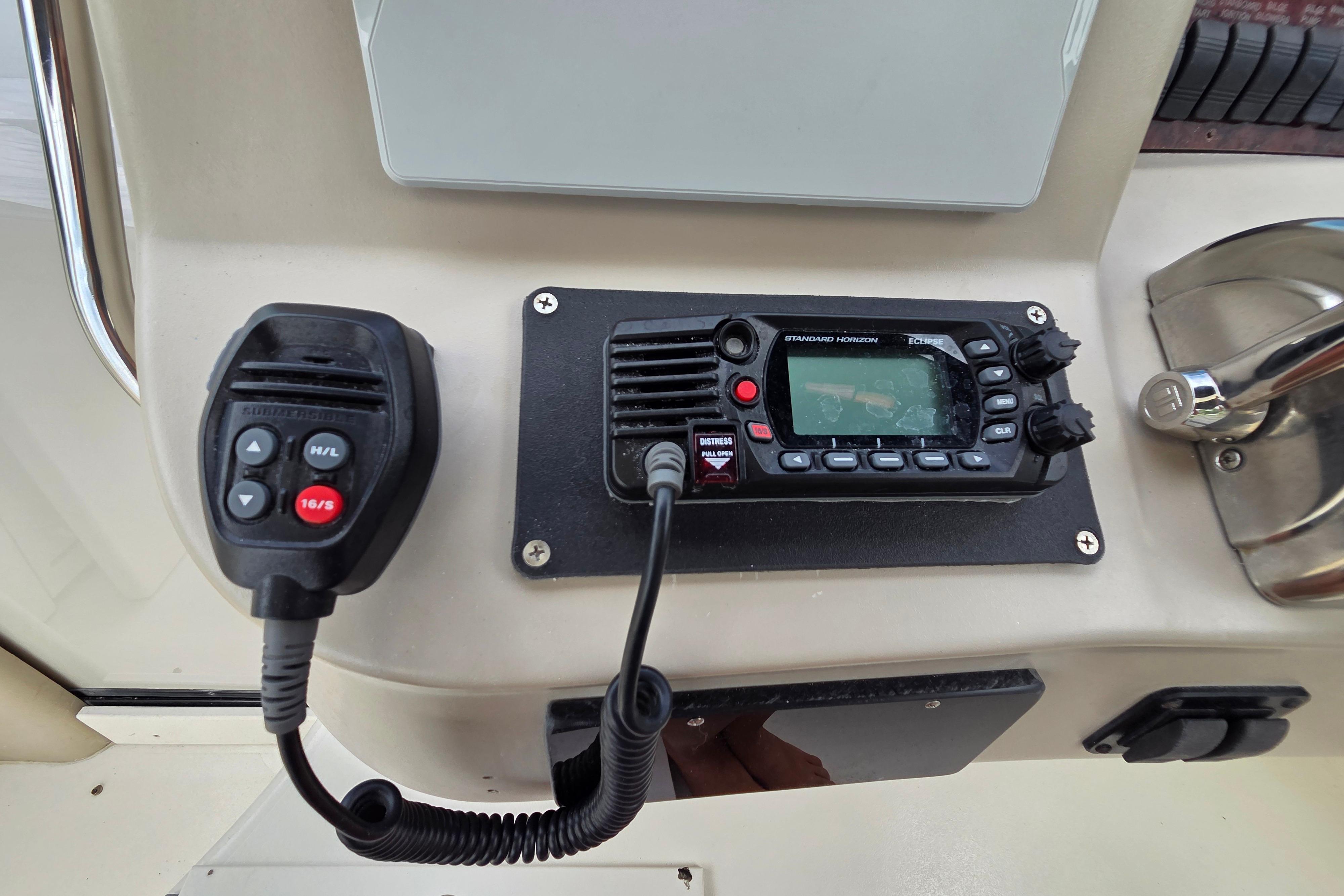 Control panel of a 2000 Sea Ray 340 Sundancer with radio and microphone.