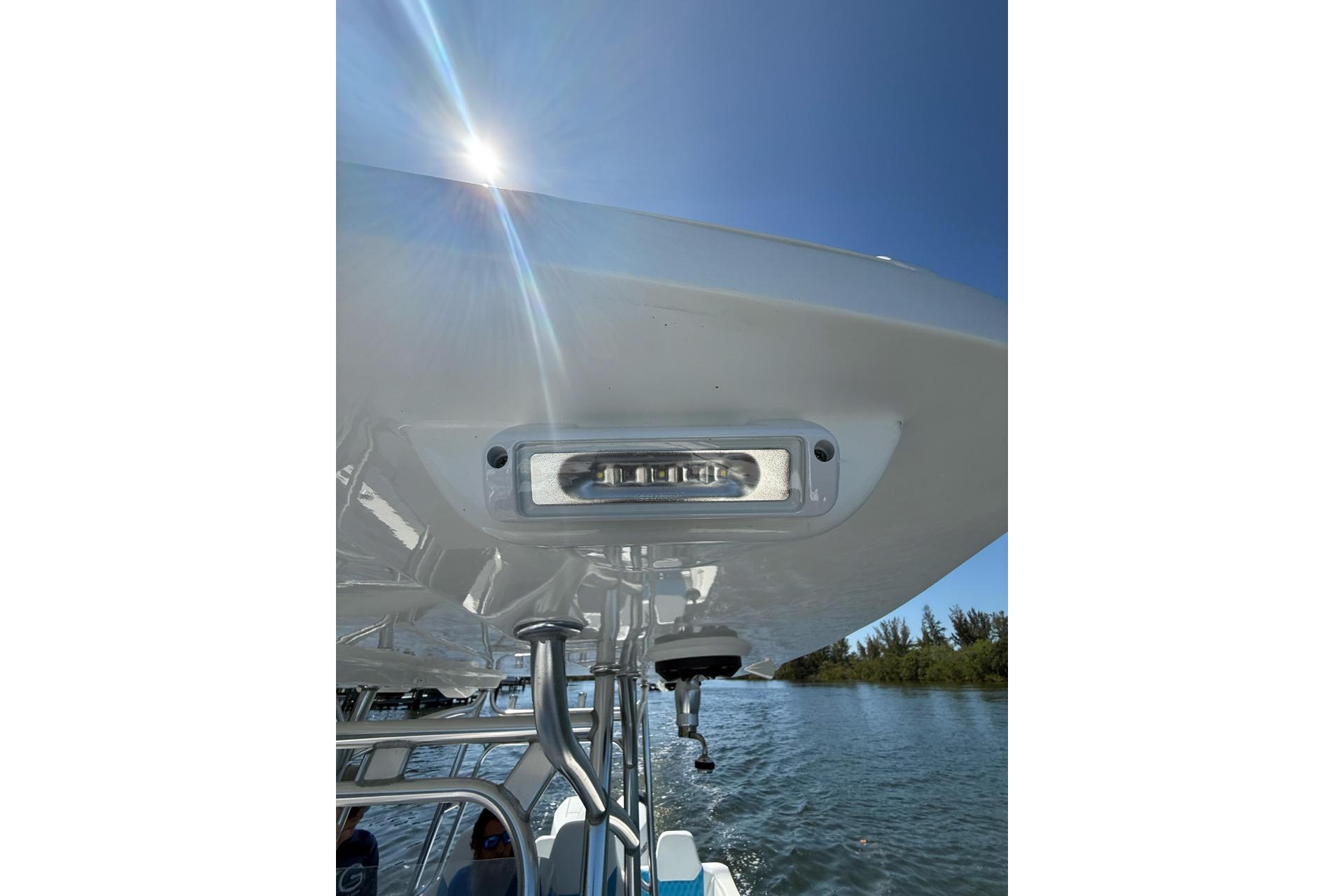 2021 Custom Infusion 34 CC boat detail with sunlight and water backdrop.