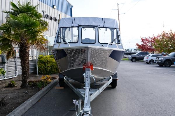 2024 Hewescraft 180 Pro-V ET boat on trailer, parked outside dealership.