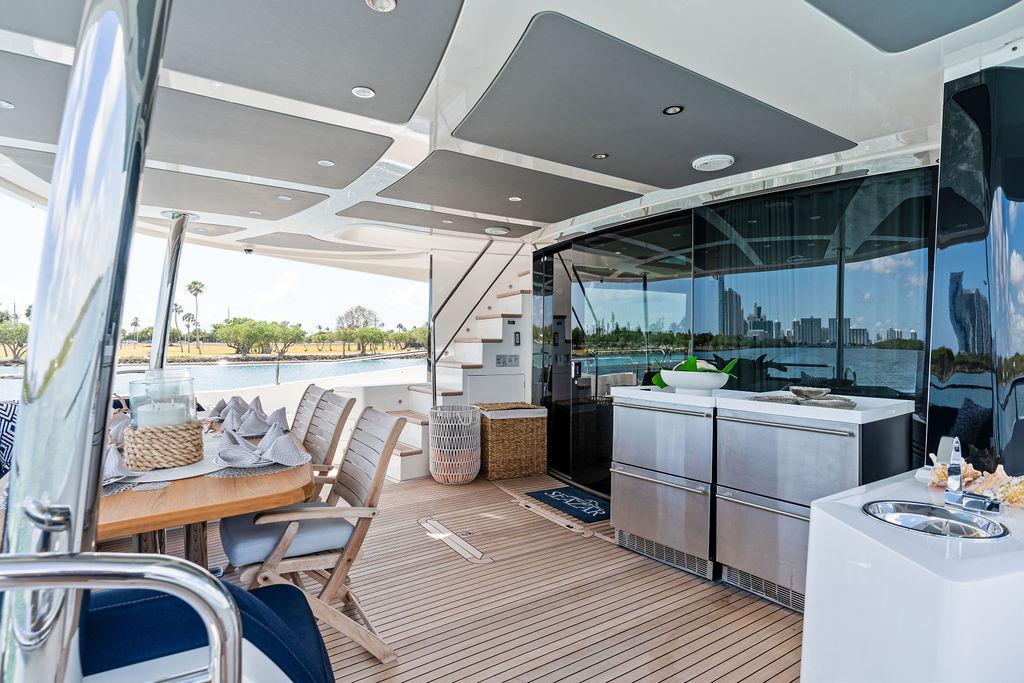 Luxurious 2019 Sunseeker 86 Yacht deck with dining area and modern amenities.
