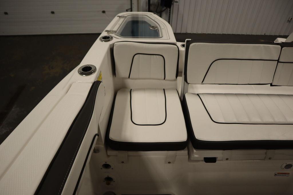 2026 Yamaha Boats 255 FSH Sport E interior seating with white upholstery and black trim.