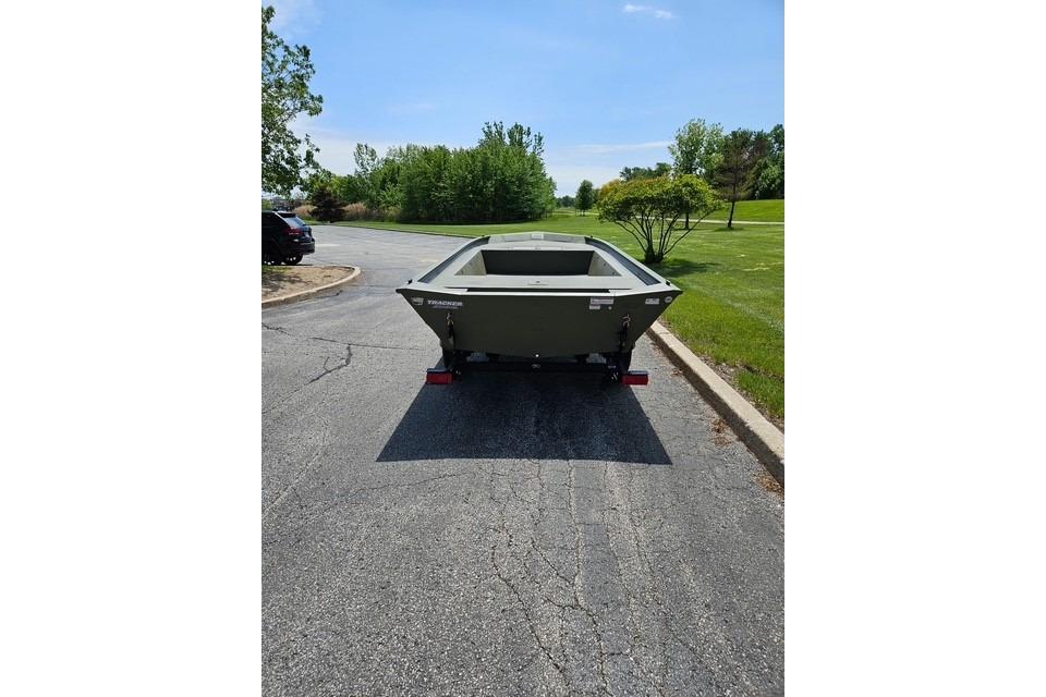 2026 Tracker Grizzly 1754 Utility boat on trailer in parking lot.
