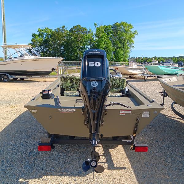 2025 Tracker Grizzly 1754 SC boat with Mercury 60 engine, parked outdoors.