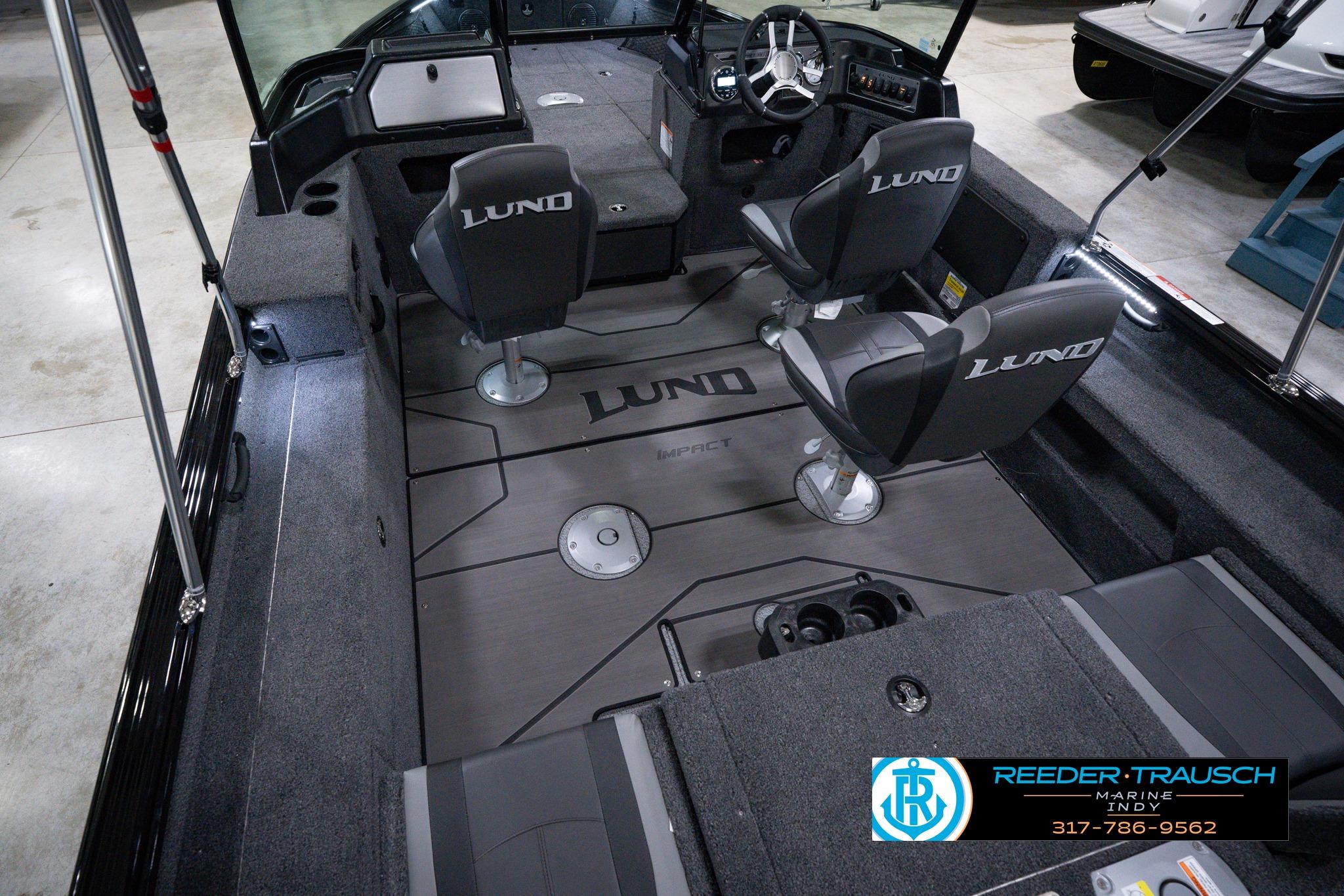2026 Lund 1875 Impact XS SS boat interior with seating and steering console, showcased at Reeder-Trausch Marine.