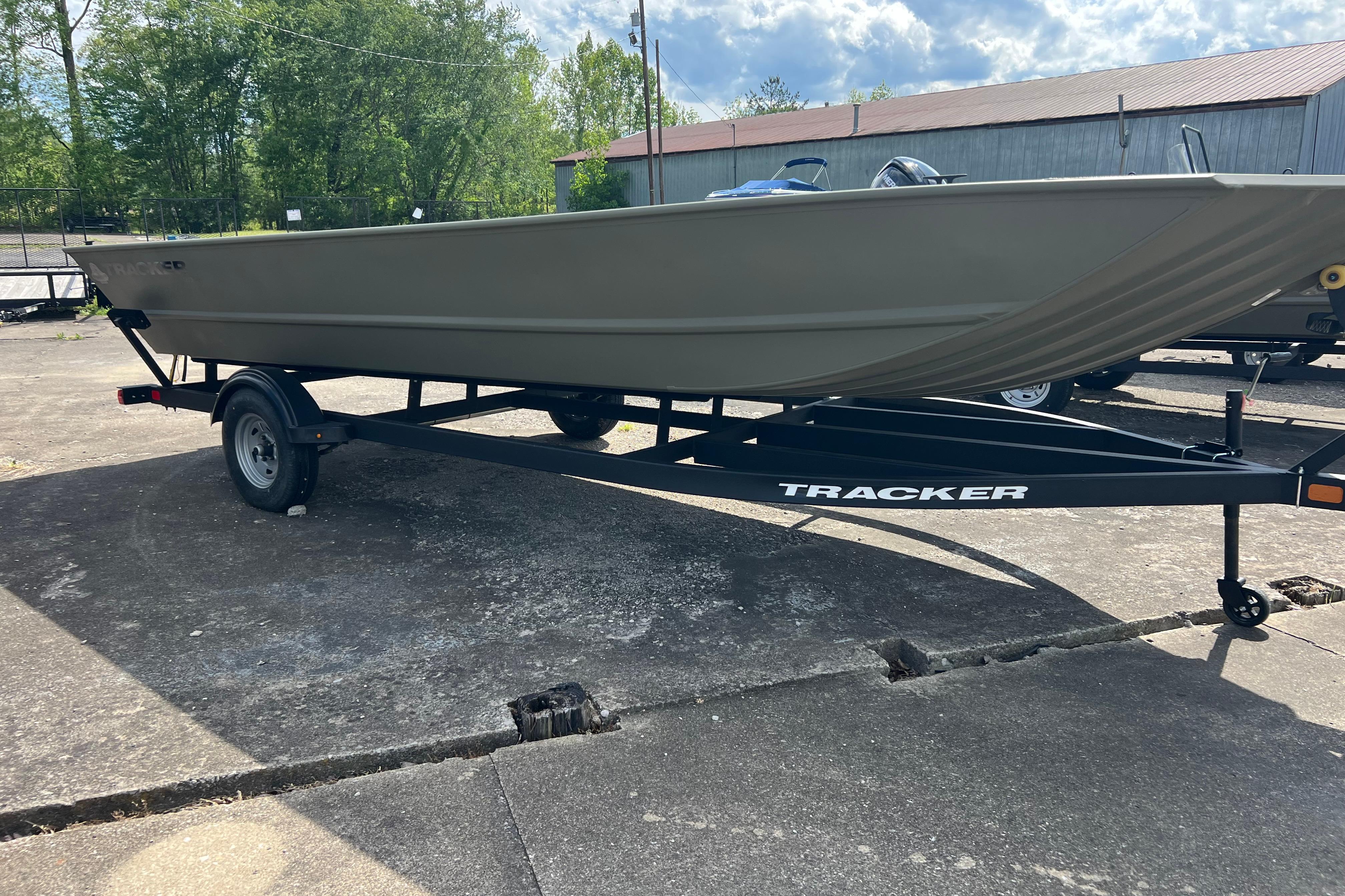 2025 Tracker Grizzly 2072 Utility boat on trailer, parked outdoors.