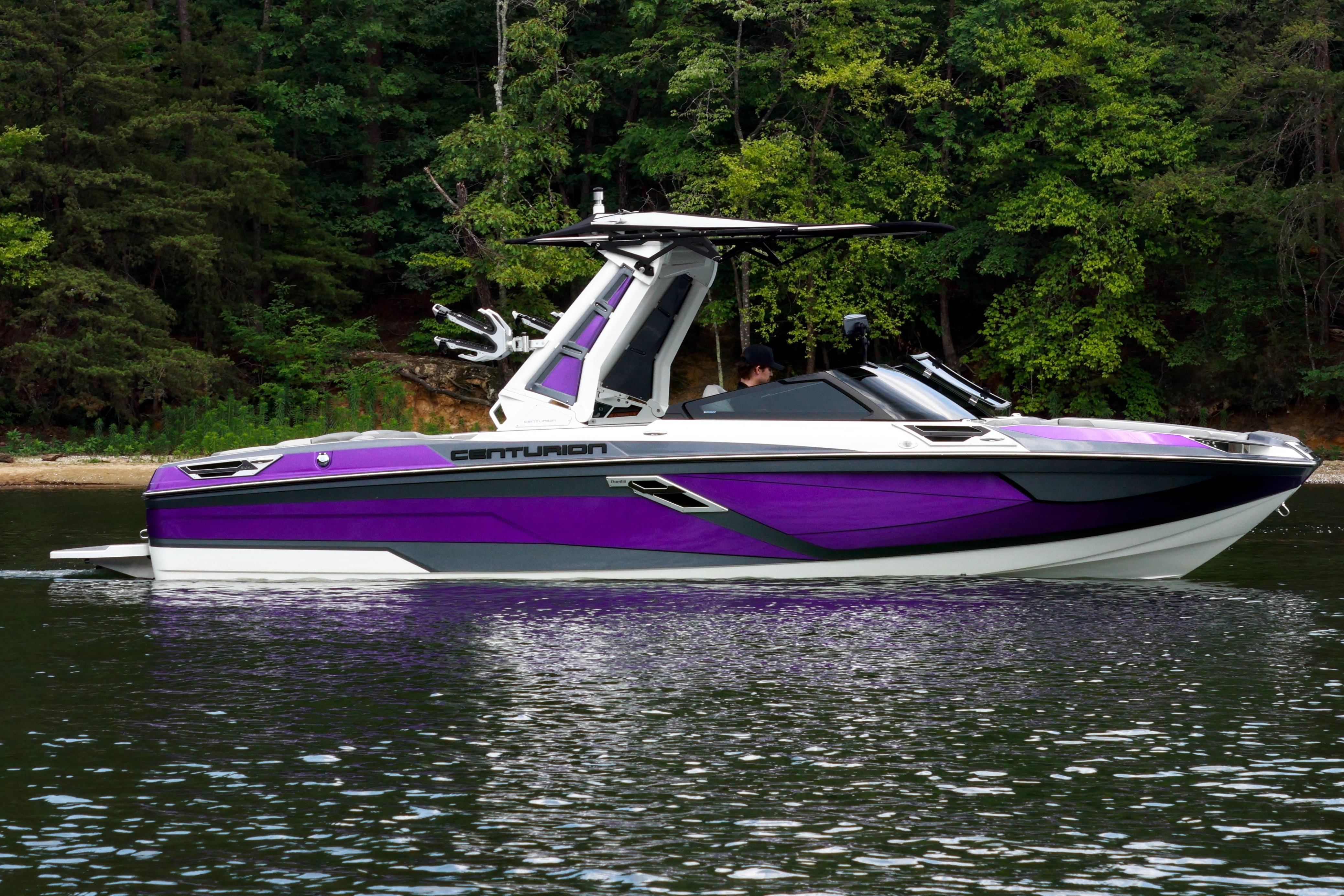 2022 Centurion Ri245 boat in vibrant purple on a serene lake.