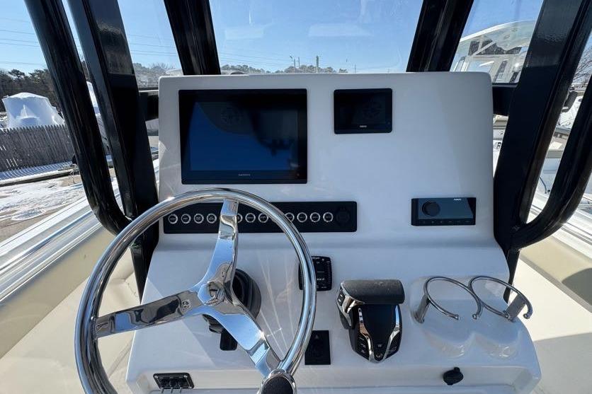 2026 Key West 239 FS boat dashboard with steering wheel and electronic displays.