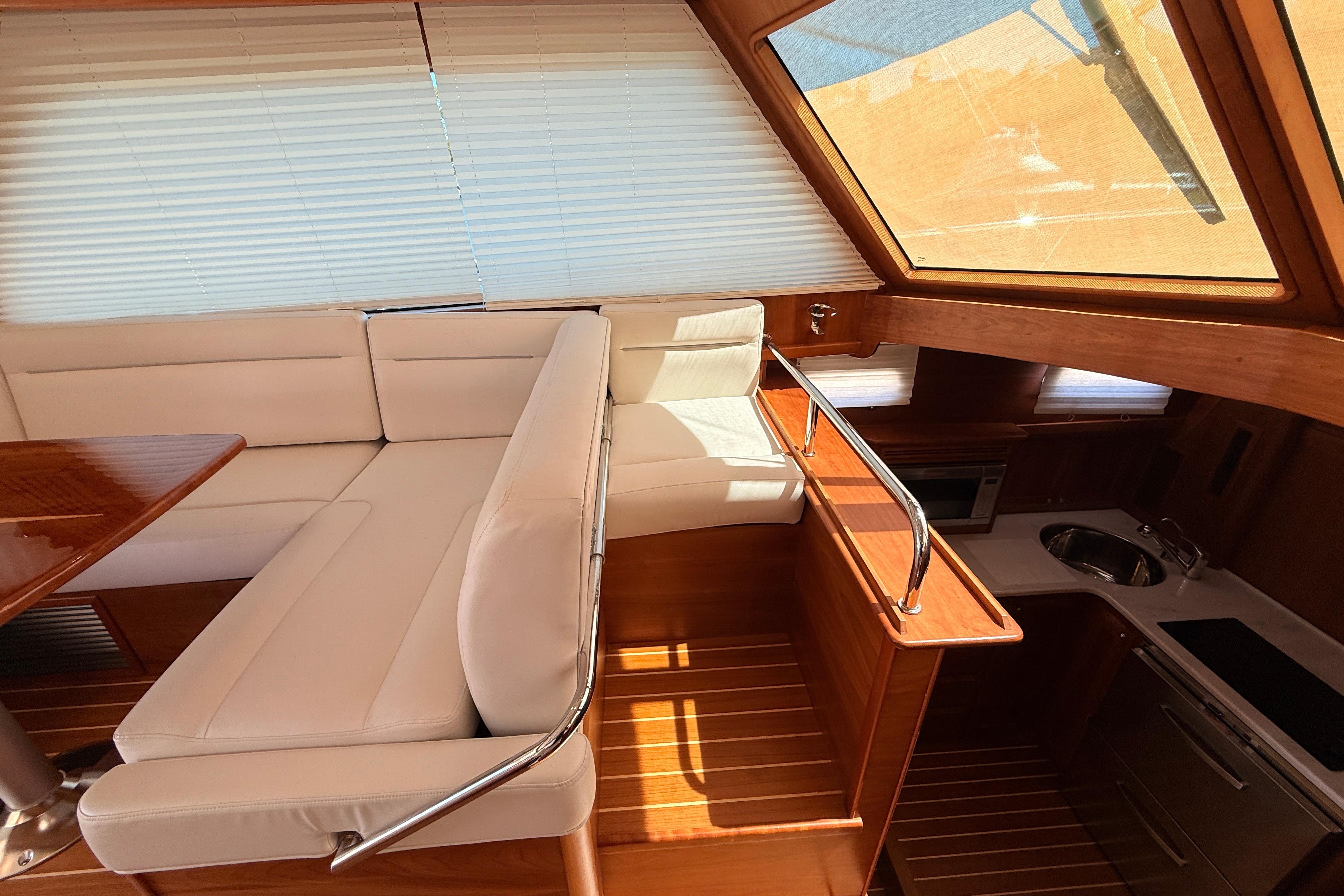 Interior of 2022 Sabre 38 Salon Express yacht with elegant seating and kitchen area.
