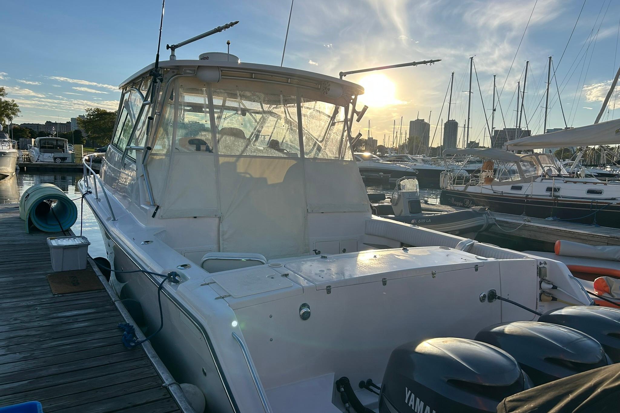 2007 Grady-White Express 360 boat docked at marina during sunset.