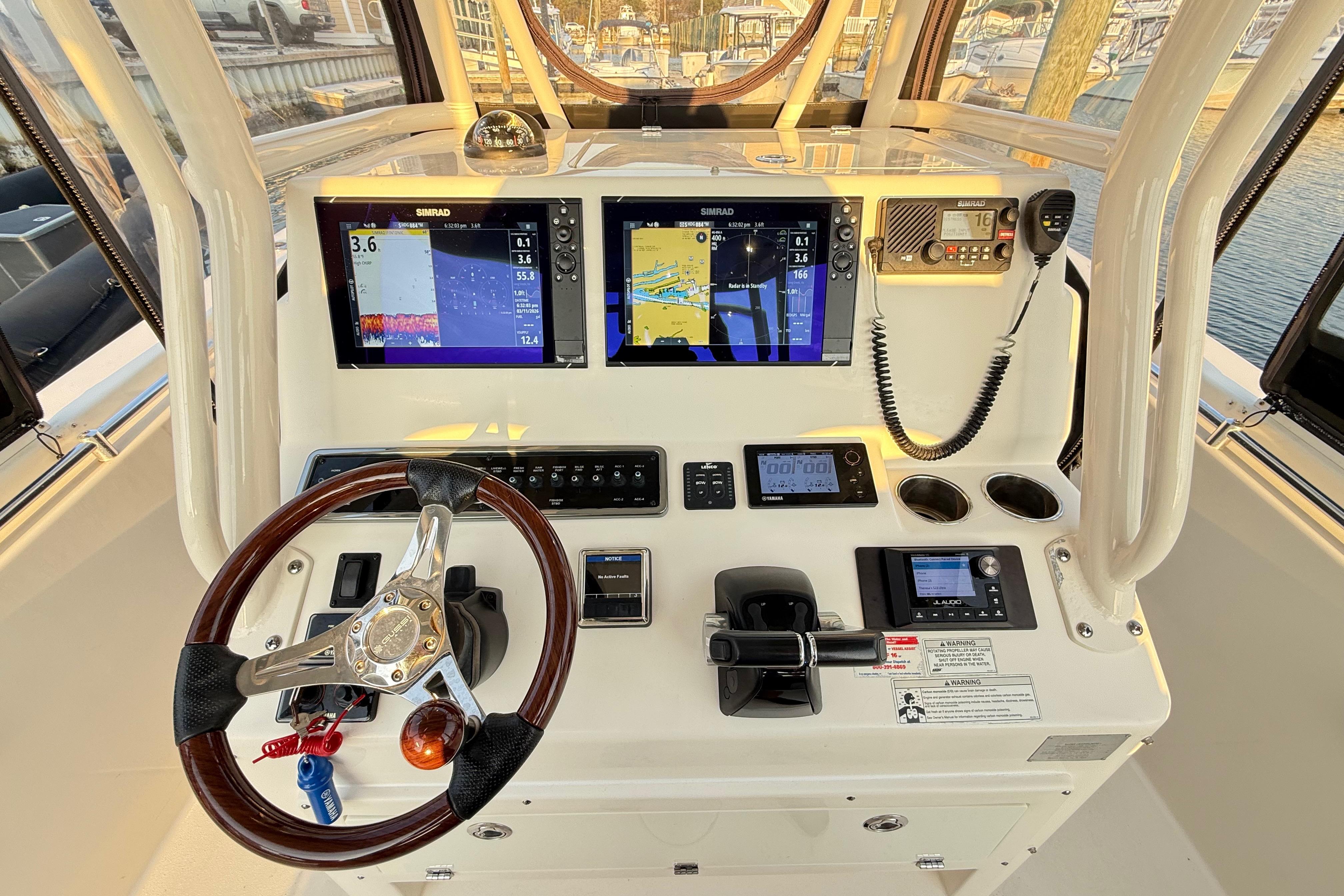 2016 Cobia 296 Center Console helm with dual Simrad displays and modern controls.
