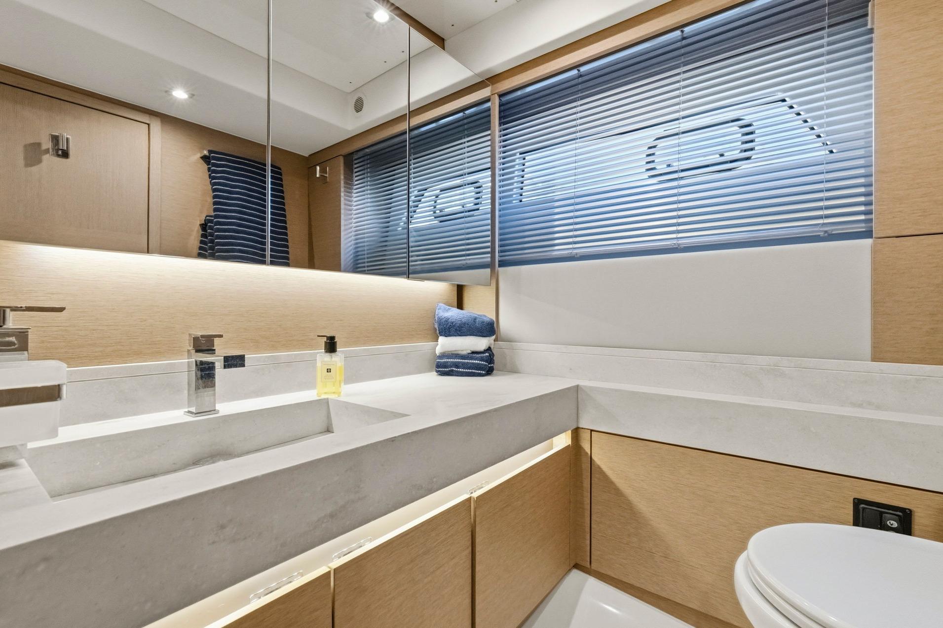 Luxurious bathroom in 2022 Prestige 520 yacht with modern fixtures and elegant design.