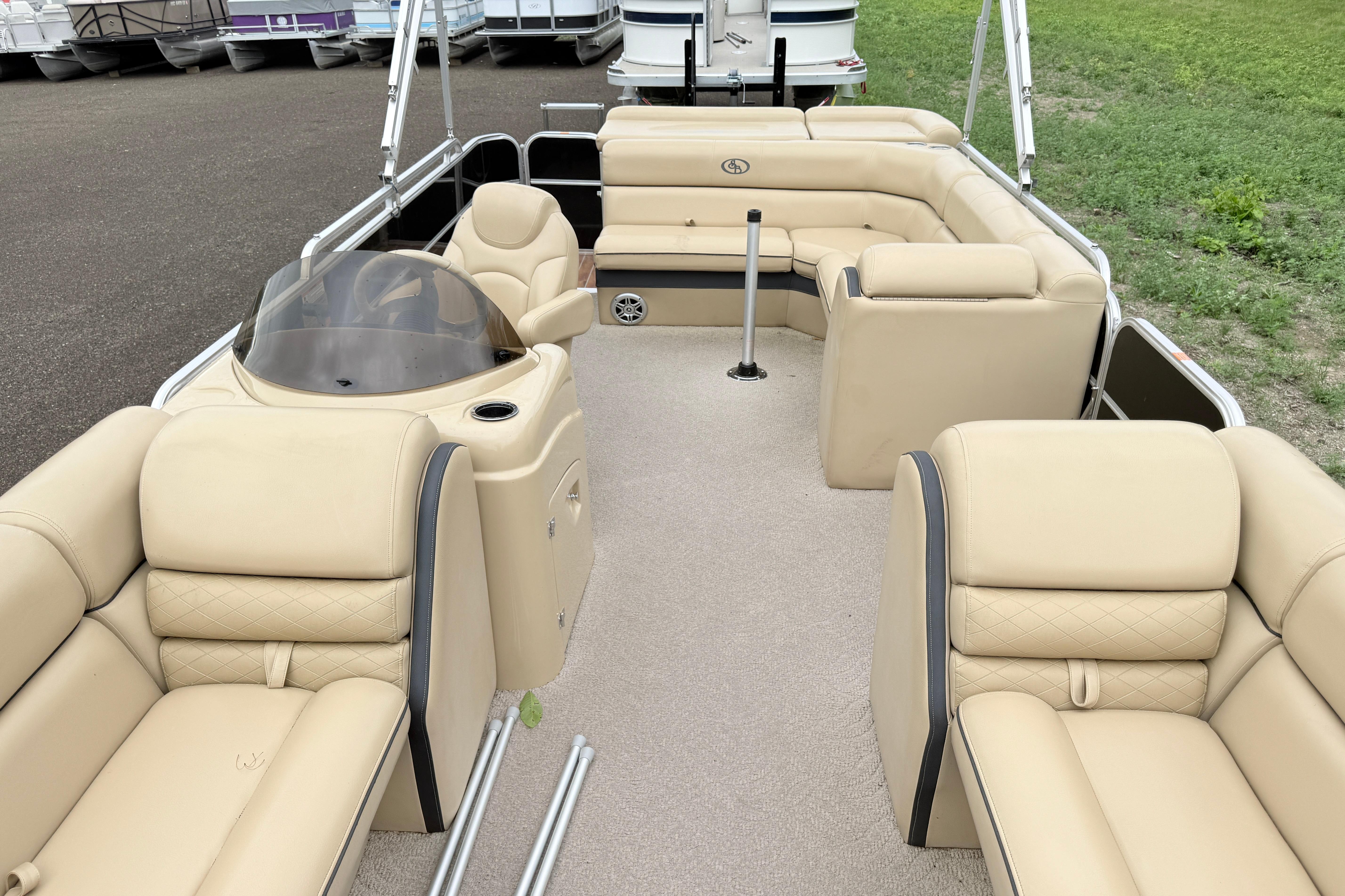 2013 South Bay 522CR pontoon boat with beige seating and spacious deck layout.
