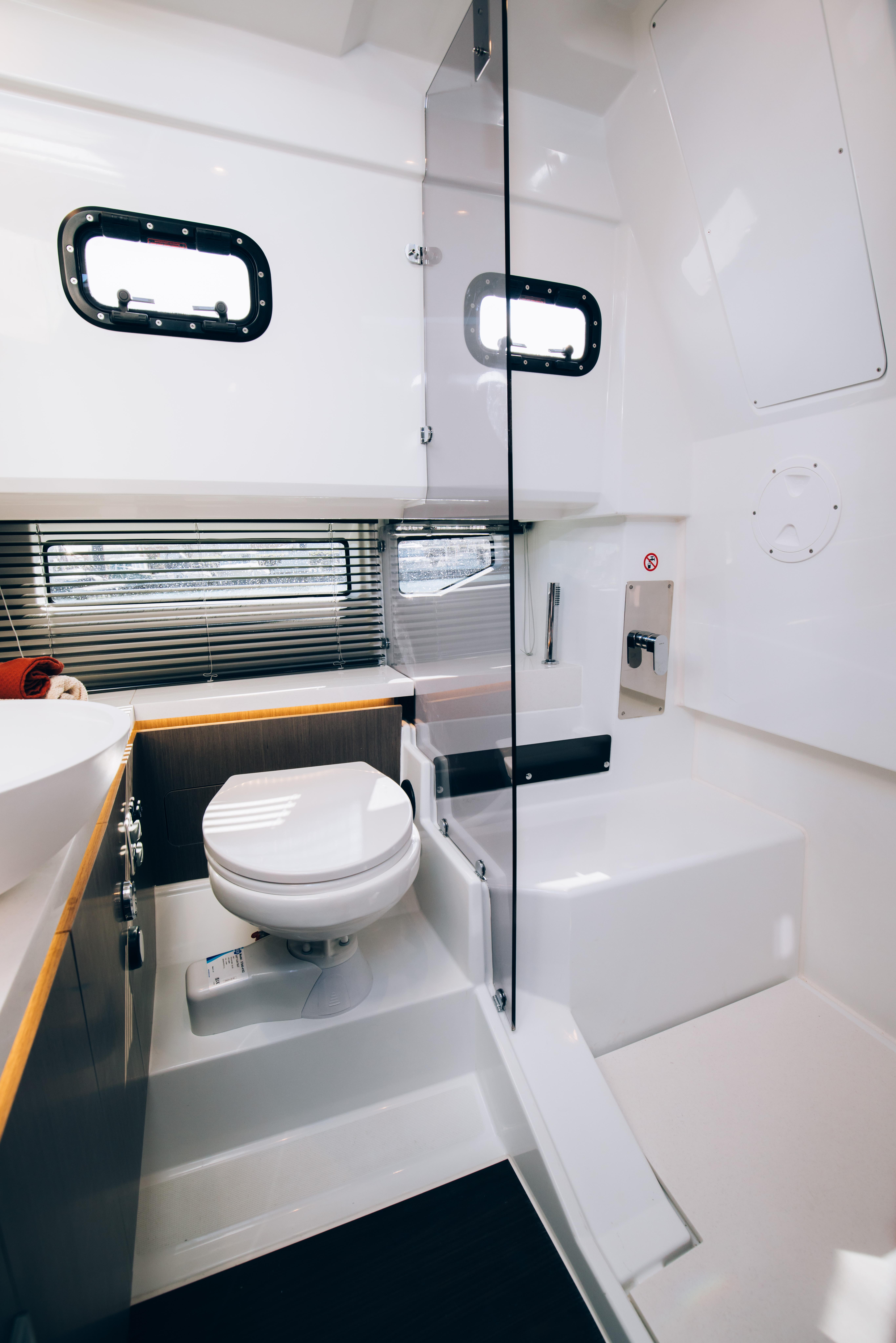 Modern bathroom in 2024 Wellcraft 355 boat with sleek design and ample natural light.