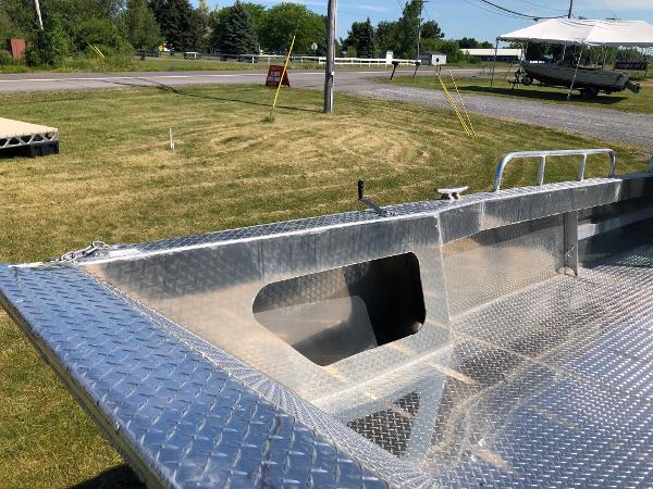 A sturdy workboat with an aluminum deck, ideal for shallow water operations.