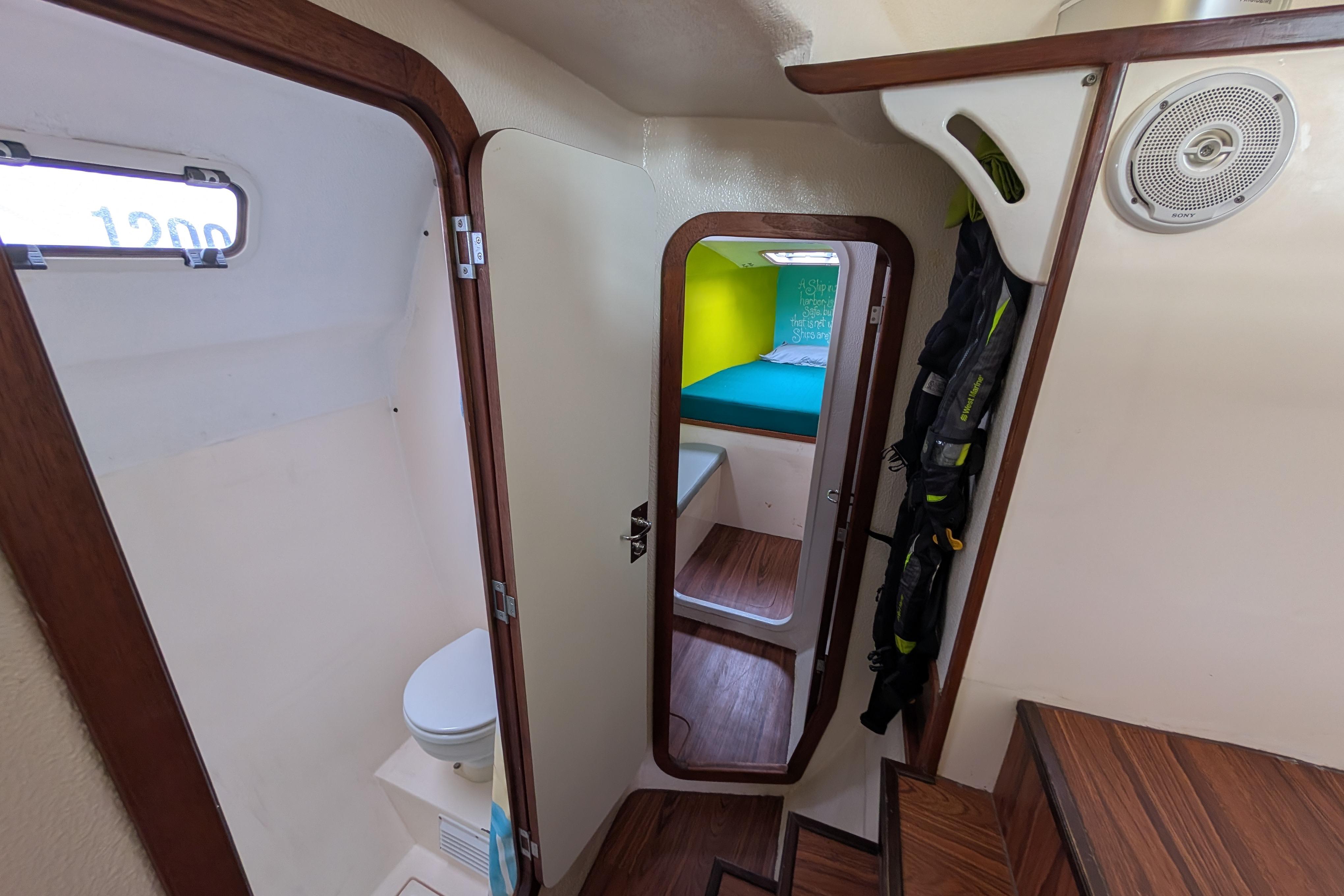 Interior of 1999 Island Spirit 37 yacht, featuring cabin, bathroom, and wooden accents.