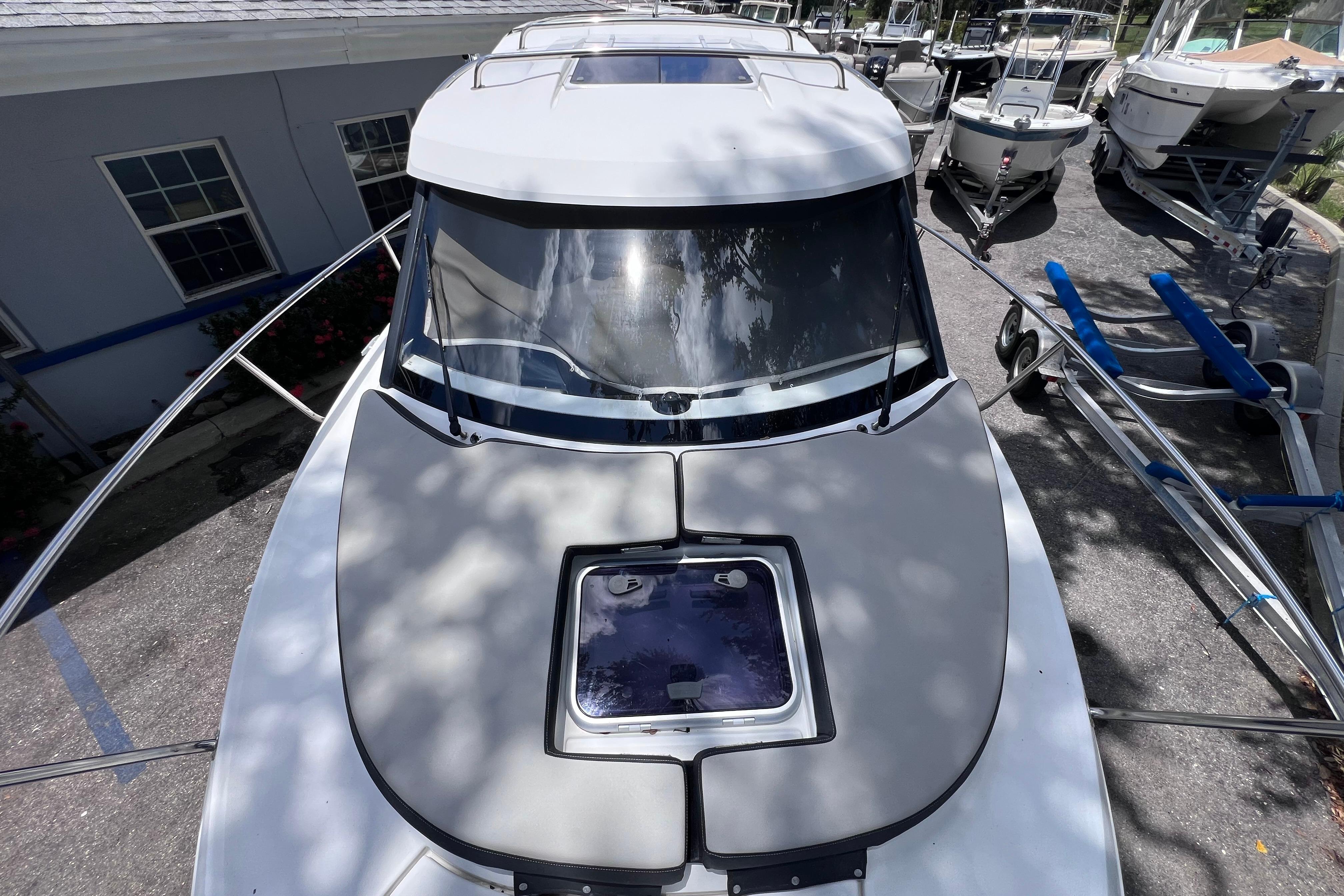 2021 Jeanneau NC Weekender 795 Series 2 boat, docked with visible sunroof and windshield.