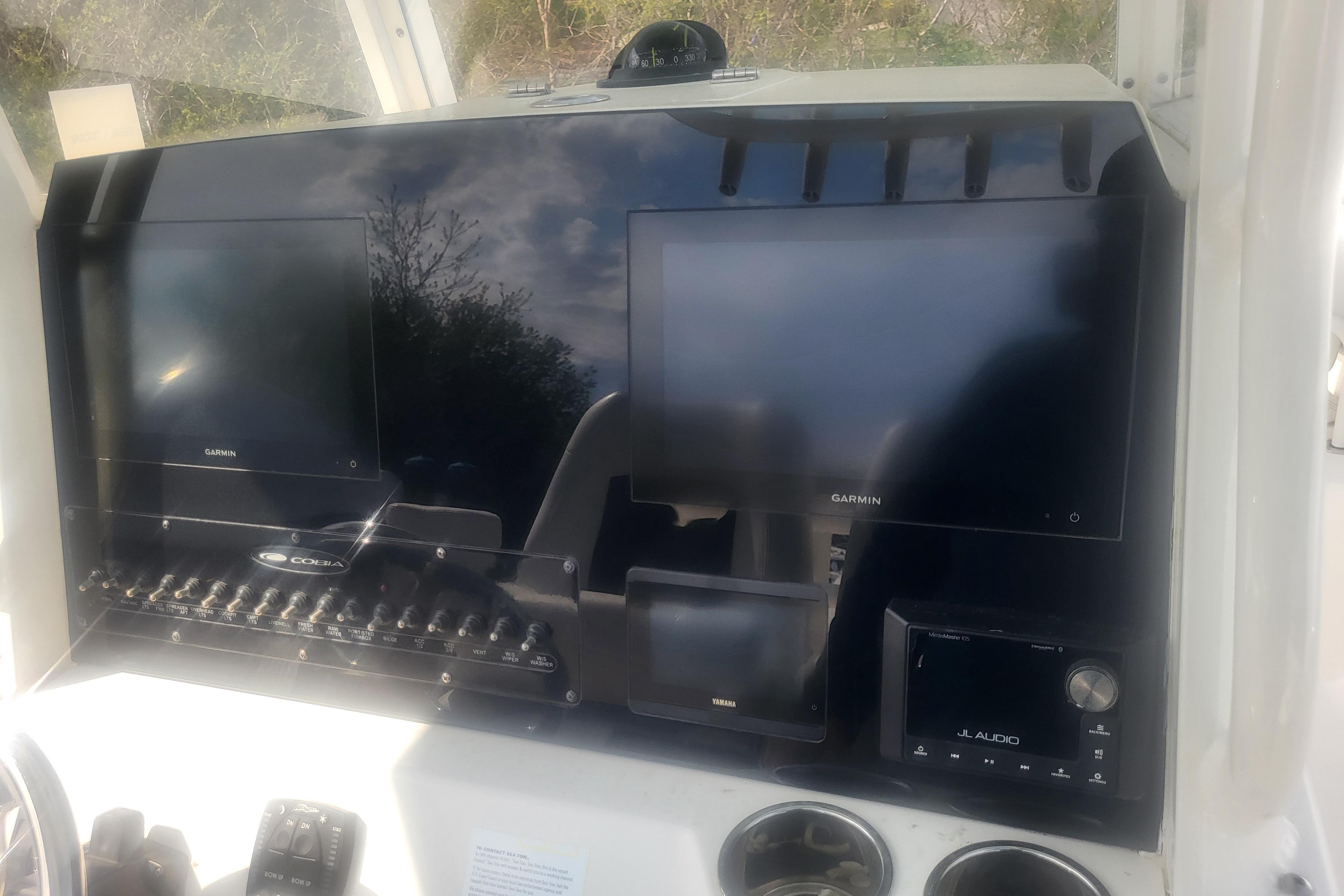 Center console of 2022 Cobia 262 boat with Garmin displays and JL Audio system.