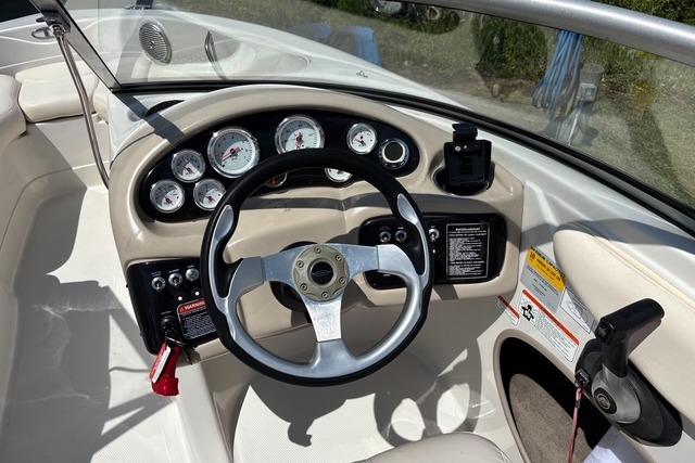 2012 Tahoe Q8 SSi boat dashboard with steering wheel and instrument panel.