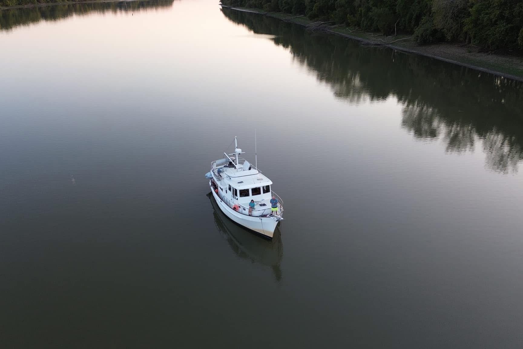 Kadey-Krogen 39 yacht from 2001 on calm river at sunset.