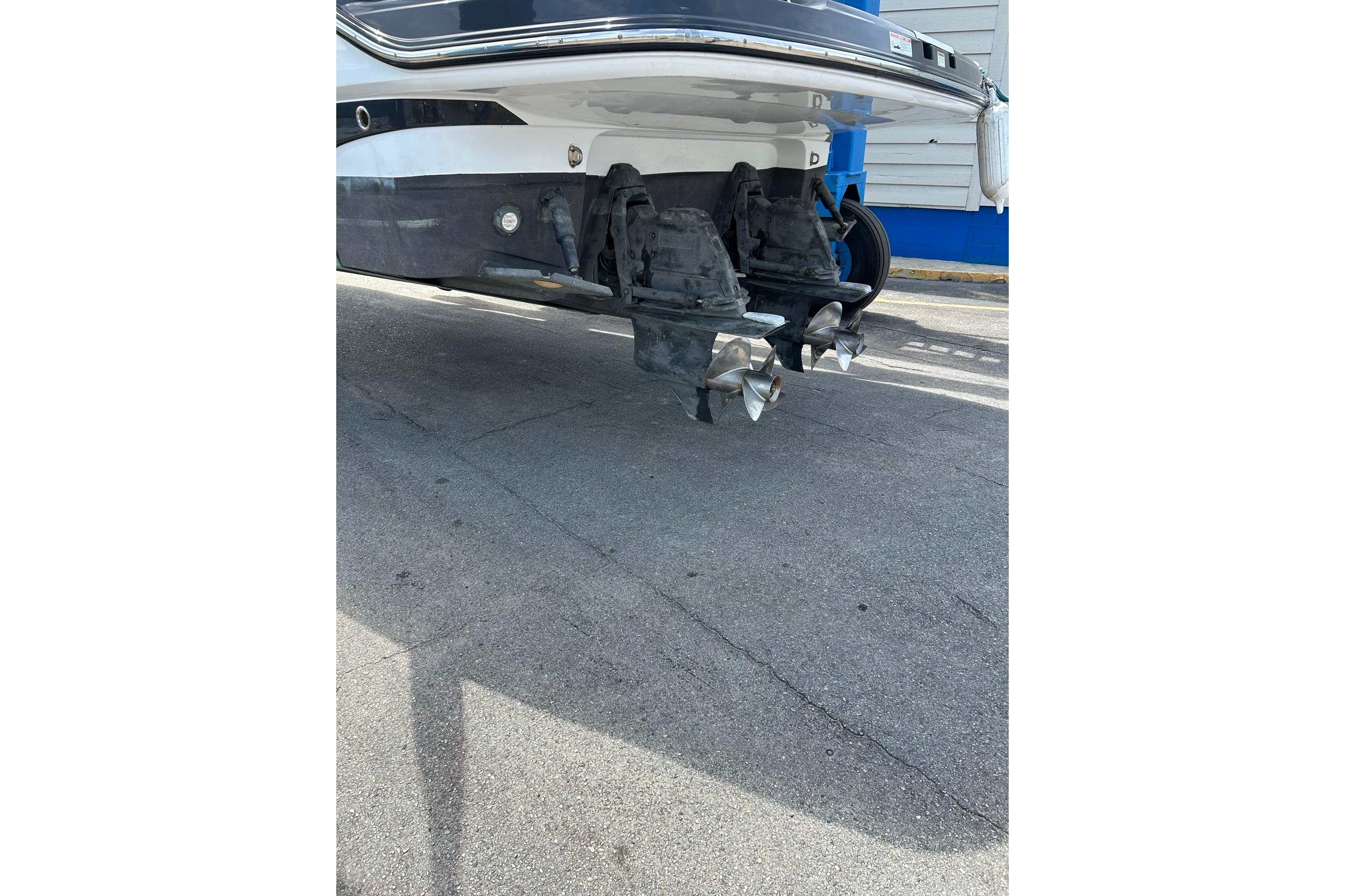 2019 Monterey 335 Sport Yacht propellers and stern view on pavement.
