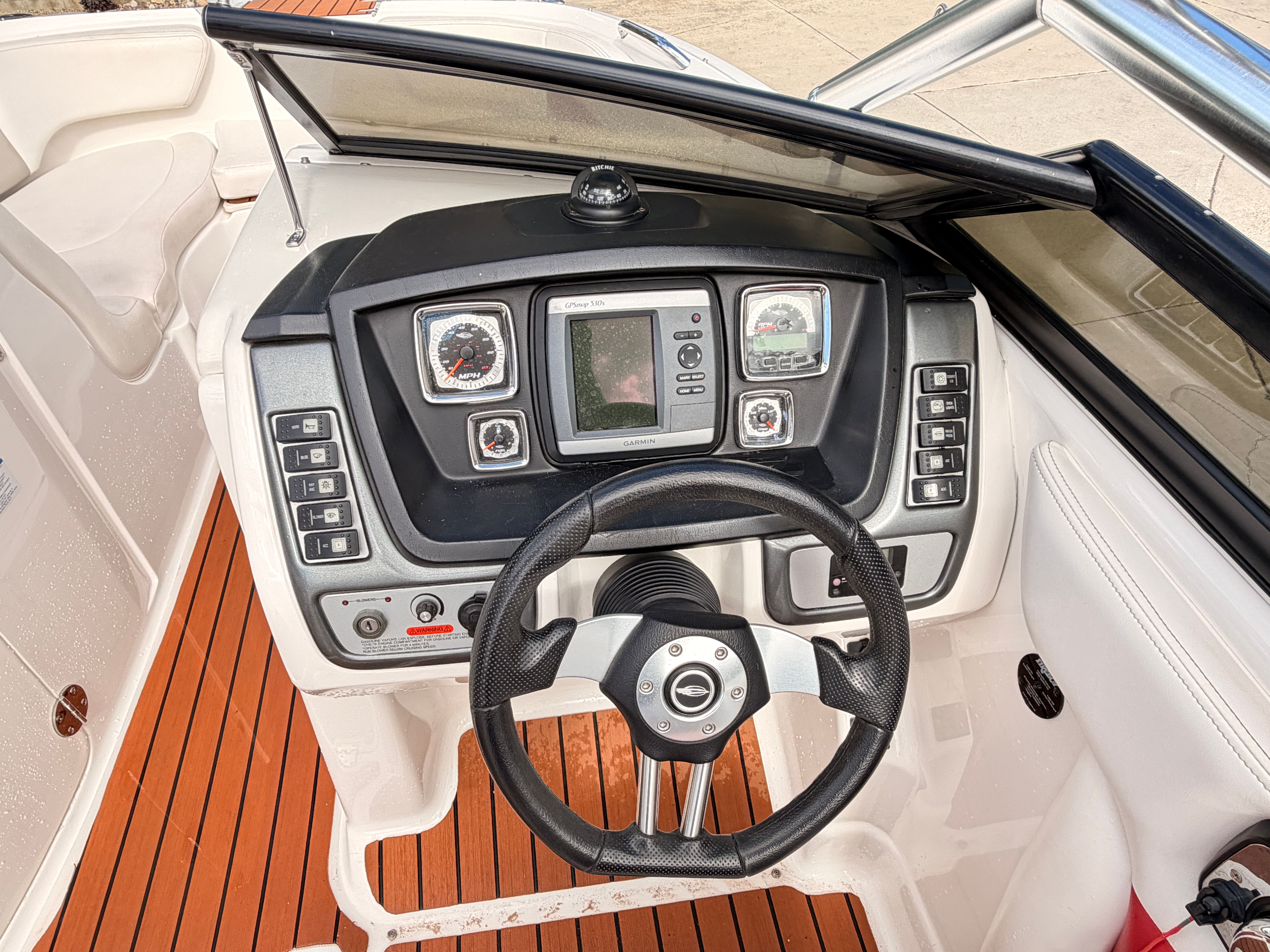 The image shows the cockpit of a 2008 Chaparral Sunesta 224 with a modern helm.