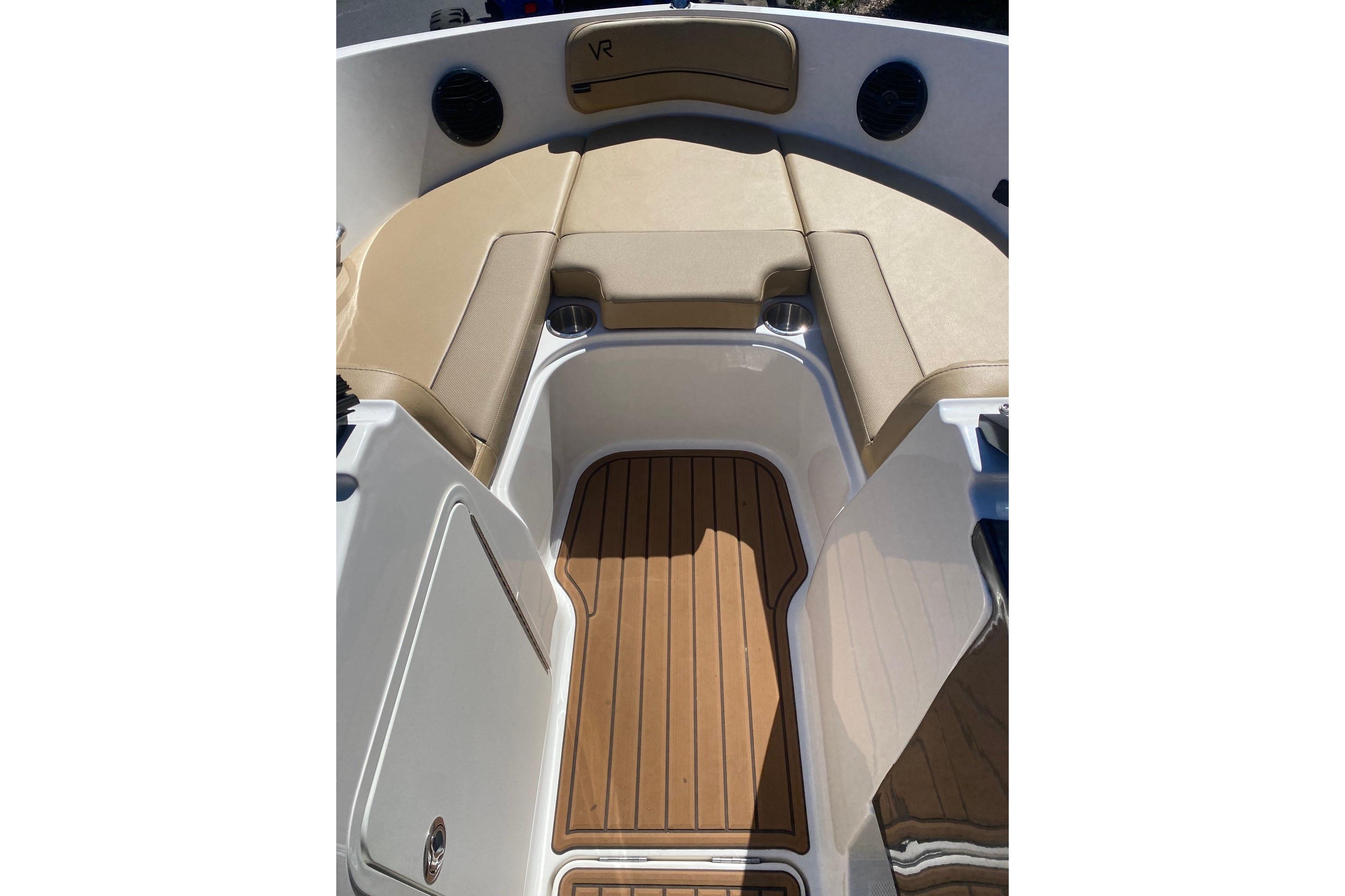 2023 Bayliner VR5 Bowrider I/O interior with tan seating and wood-style flooring.